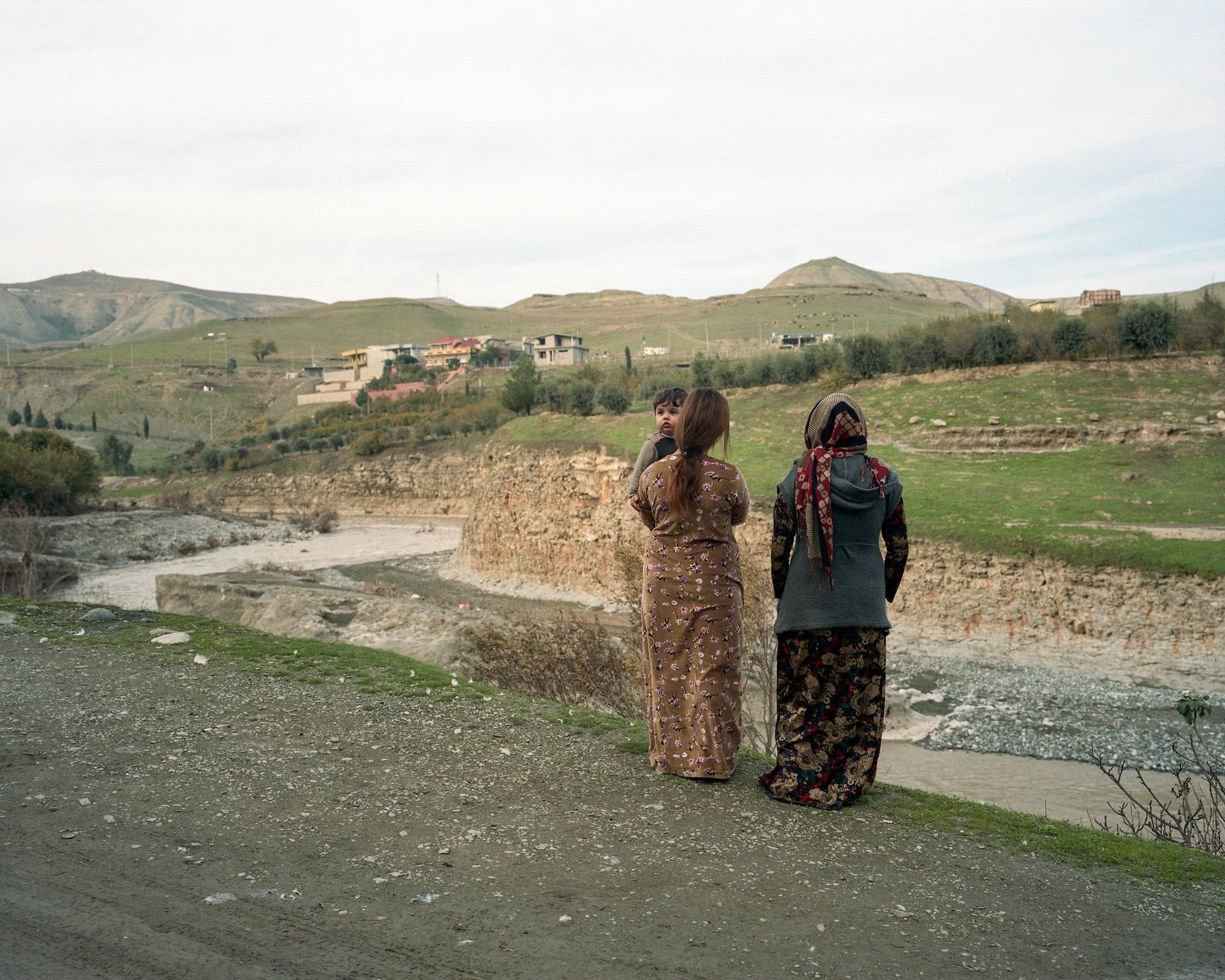  Kurdish women and child at Rawanduz river, a key tributary of the Greater Zab River. Soran, Iraq. 