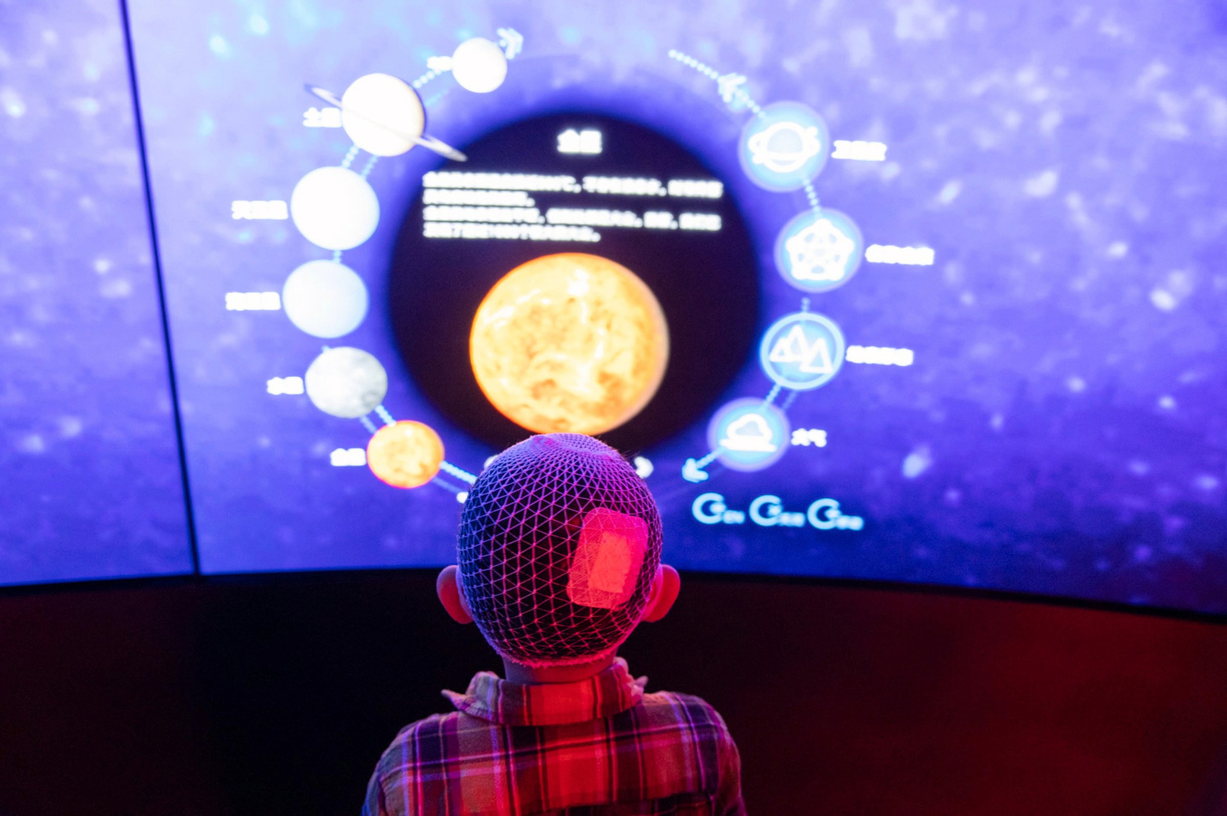  Visitor at the Shanghai Astronomy Museum, the world's largest planetarium. In the last decade China is investing into many space related projects and facilities to popularize space exploration and inspire the younger generations.  