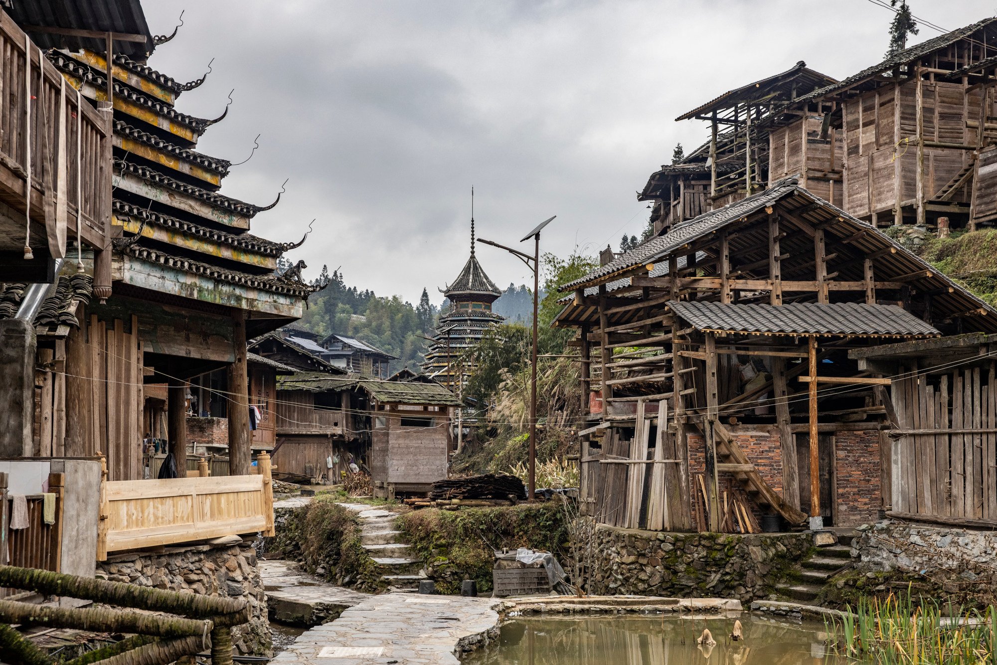  A traditional Dong minority village with octagonal pagoda-type drum towers. Villagers gather around the fire in the middle of the tower which burns almost all year round. Huanggang village in Guizhou, China. 