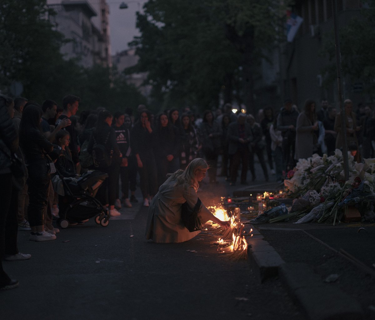  People light candles during a vigil following a shooting at a school in the Serbian capital Belgrade on May 4, 2023. Serbian police arrested a student following a shooting at an elementary school in the capital Belgrade on May 3, 2023, the interior 