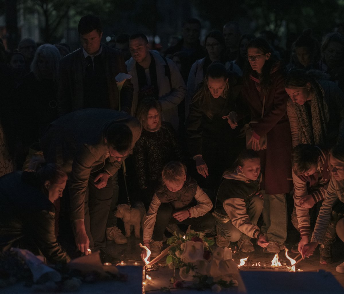  People light candles during a vigil following a shooting at a school in the Serbian capital Belgrade on May 3, 2023. Serbian police arrested a student following a shooting at an elementary school in the capital Belgrade on May 3, 2023, the interior 