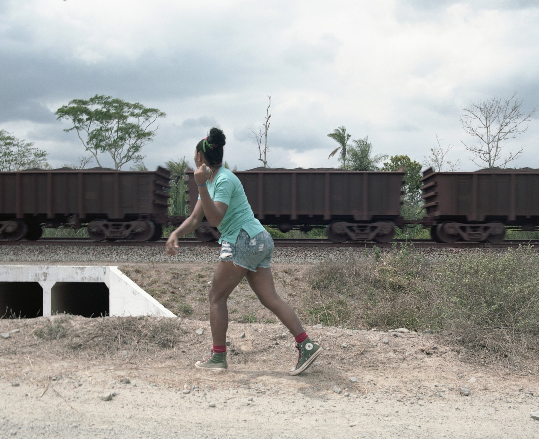  Santa Rosa do Pretos, Maranhão, Brazil, 2017. Josiclea “Zica” Pires throws a rock agains the mining company train that cross the lands of the Quilombo. The construction of the rail dried a water channel used for fishing and irrigation by the people 