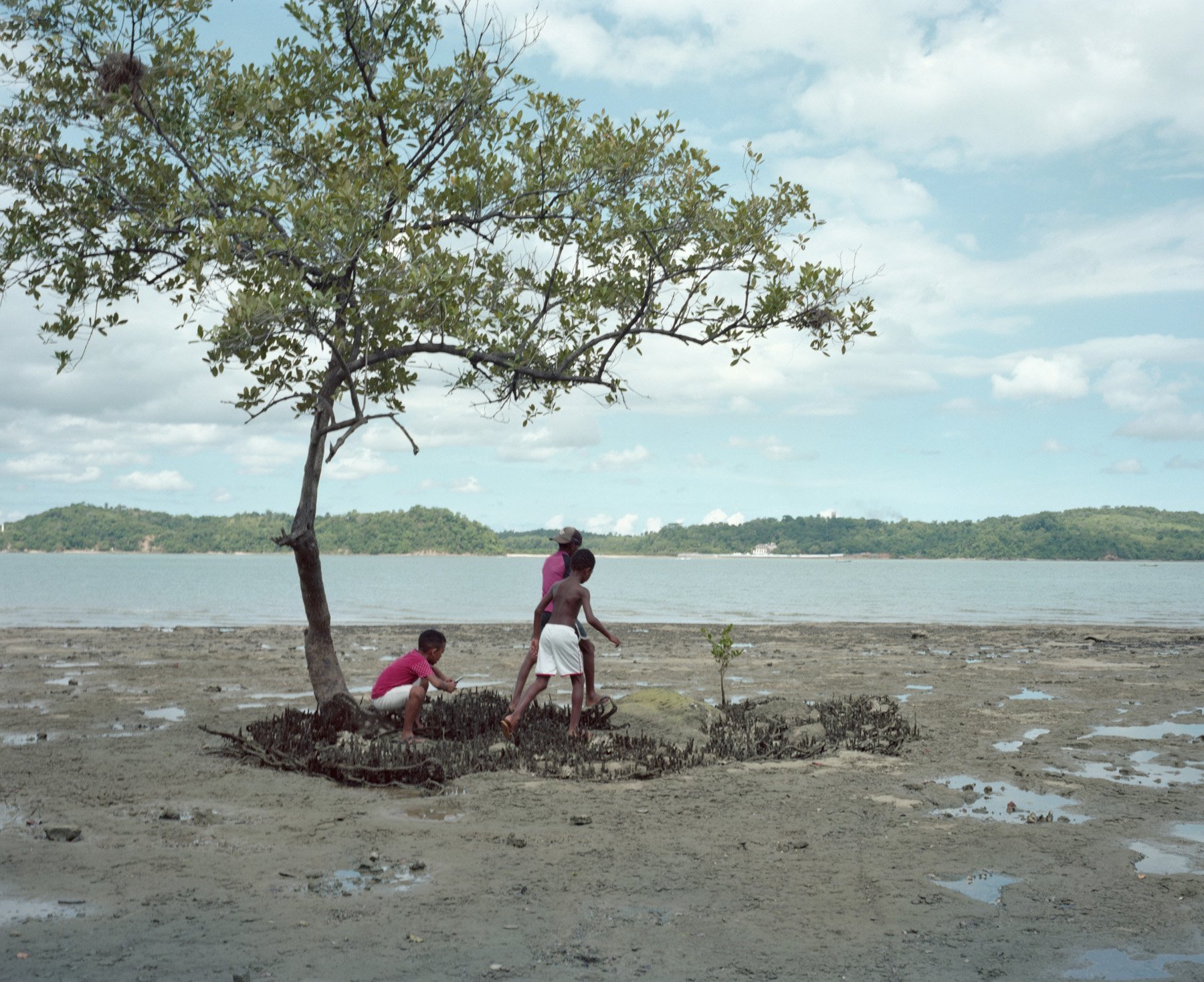  Ilha da Maré, Bahia, Brazil, 2020. Children from Ilha da Maré play while searching for seafood. The Ilha da Mare is the home of several Quilombola’s communities that live of fishing. The waters where they fish are polluted with petrochemical residue