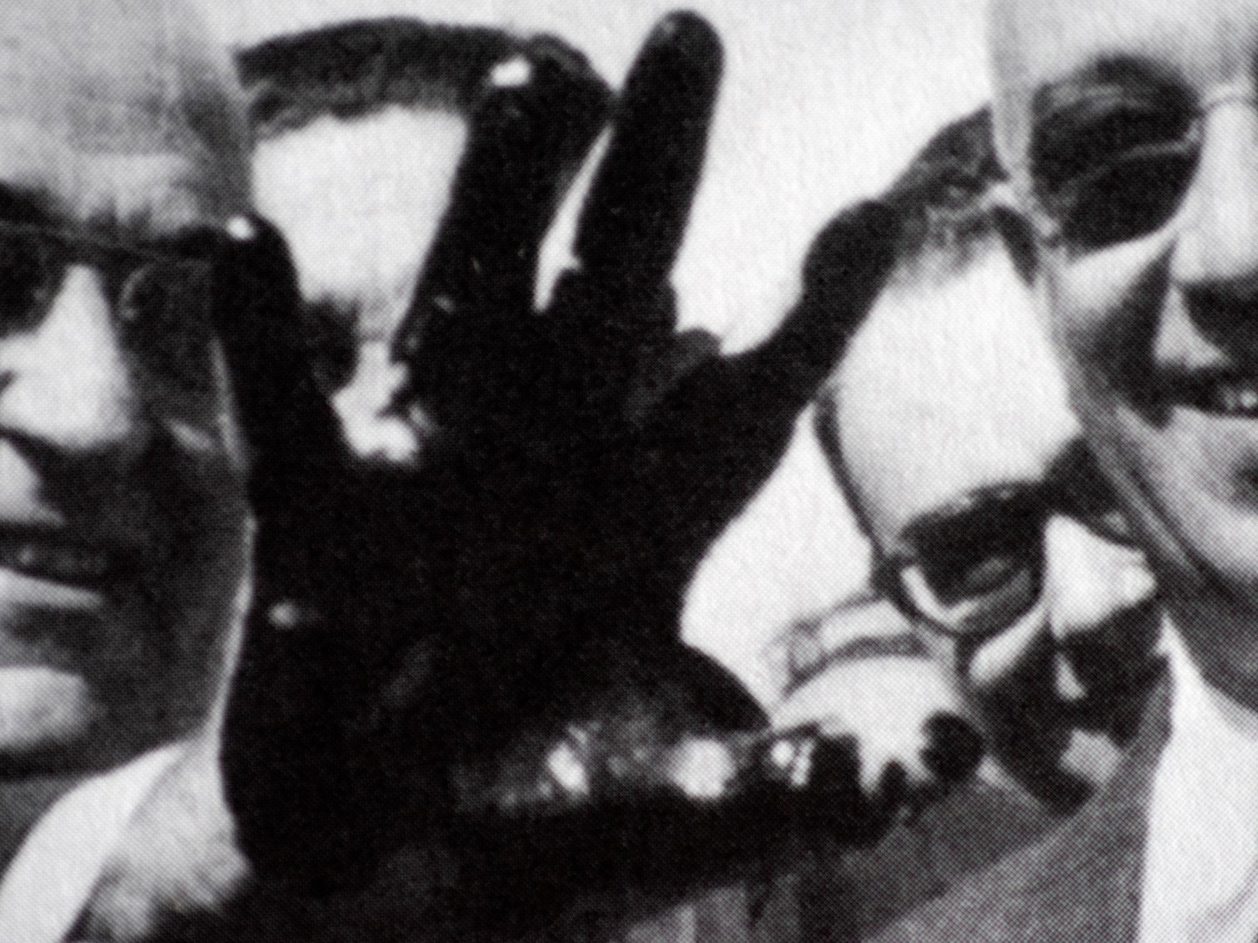  Candeias, Bahia, 2021. A detail from an archival picture of Brazilian President Getulio Vargas showing a hand stained with oil at the opening of the construction works of the Landulpho Alves Refinery. The refinery is located in front of the Ilha da 