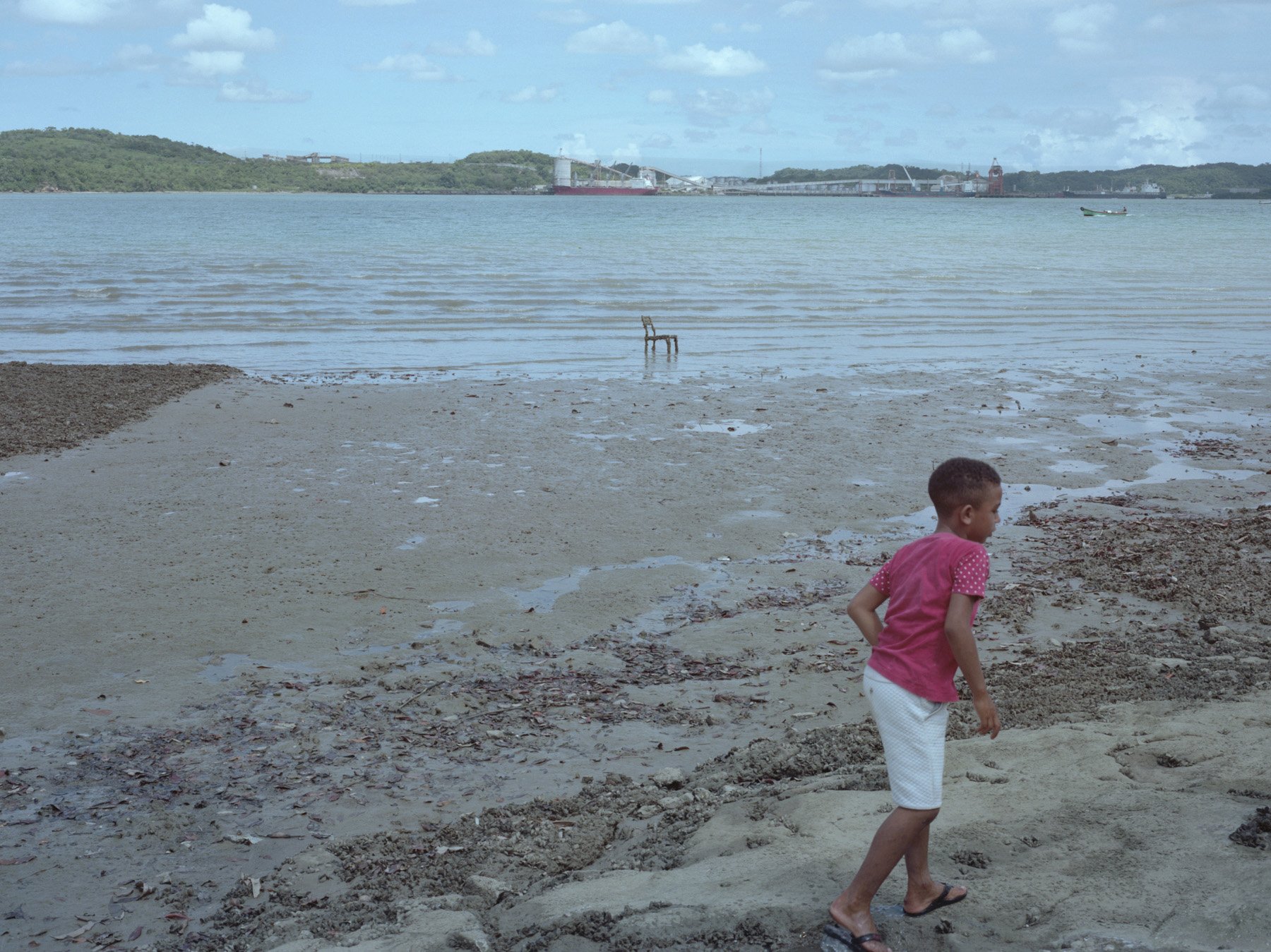  Ilha da Maré, Bahia, 2020. A child from Ilha da Maré plays while searching for seafood. The Ilha da Mare is the home of several Quilombola’s communities that live of fishing. The waters where they fish are polluted with petrochemical residues and ot