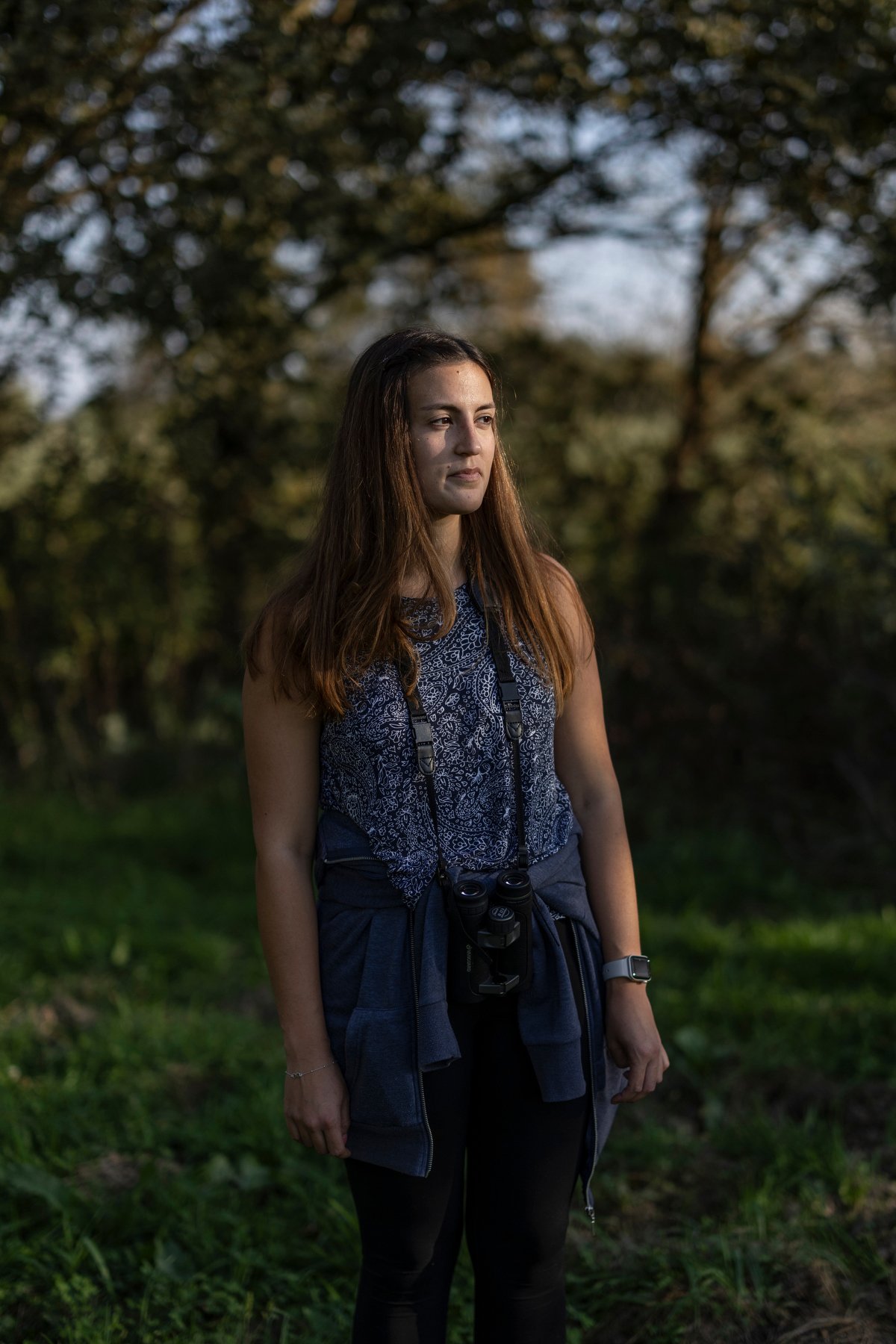  SLOVENIA. October 2023. Anja Cigan, a researcher at the Institute for Nature Conservation of Slovenia, observes migratory birds along the Mura River—a vital habitat now under threat. Climate change is disrupting migration patterns, with droughts and