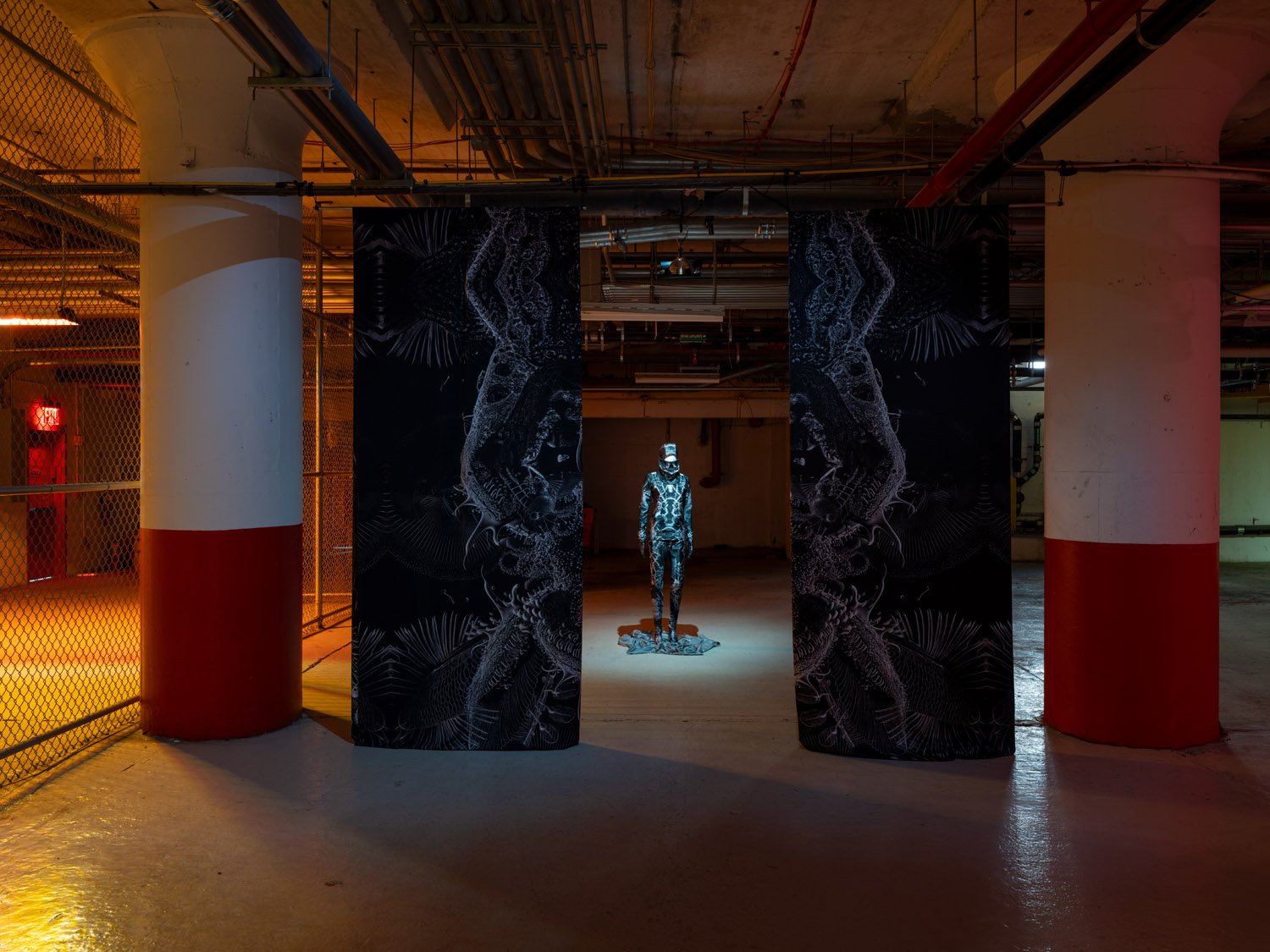    HOST - for your living things | AI - Mitosis (2023) Balaklava, turtleneck, leggings, mittens, socks and two floor-to-ceiling flags made from polyester with a high contrast black and white digital print, by Elaine Young. Image Credit: On White Wall