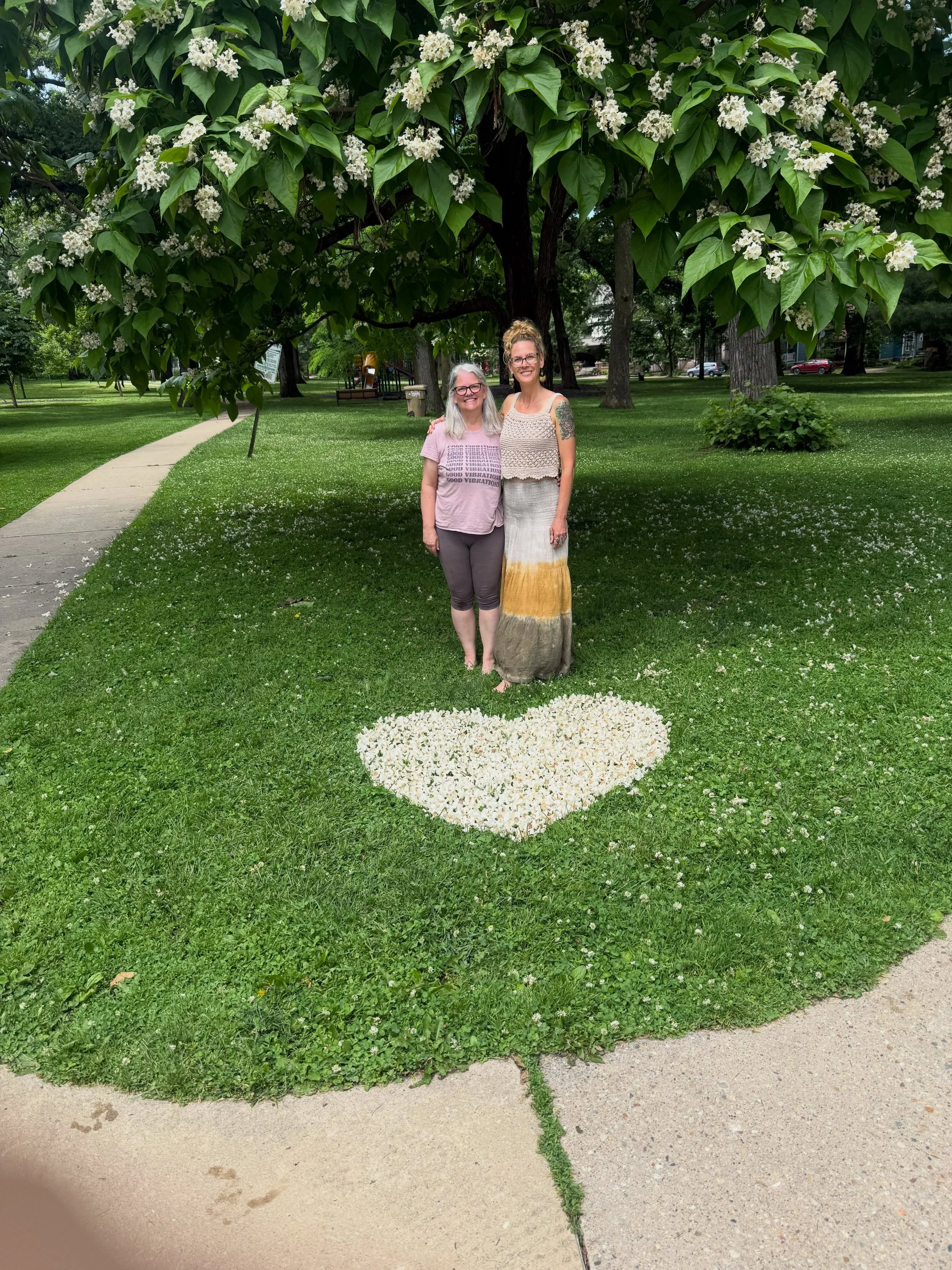 What if we could help shift our culture through simple gestures of care, presence, beauty, and genuine connection?

Yesterday, my friend Jayne and I met for a walk and came across a Catalpa tree in Orton Park shedding its blossoms. The ground was cov