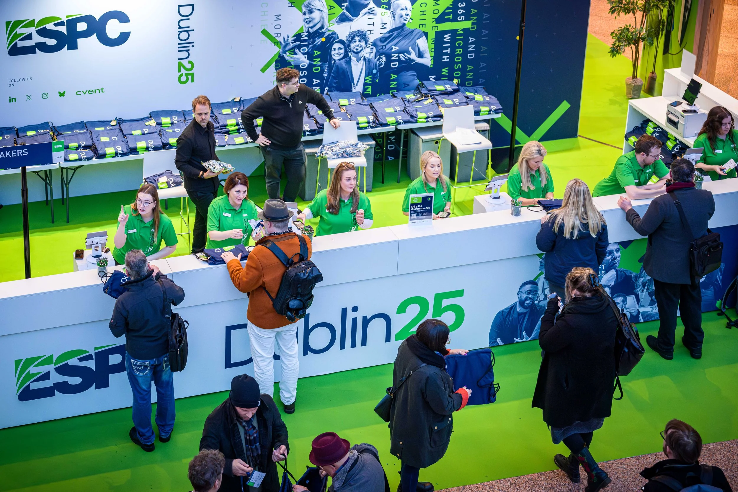 Large event registration desk with staffed iPad check-in and on-site badge printing, delivering flexible registration support and instant badge collection for attendees.