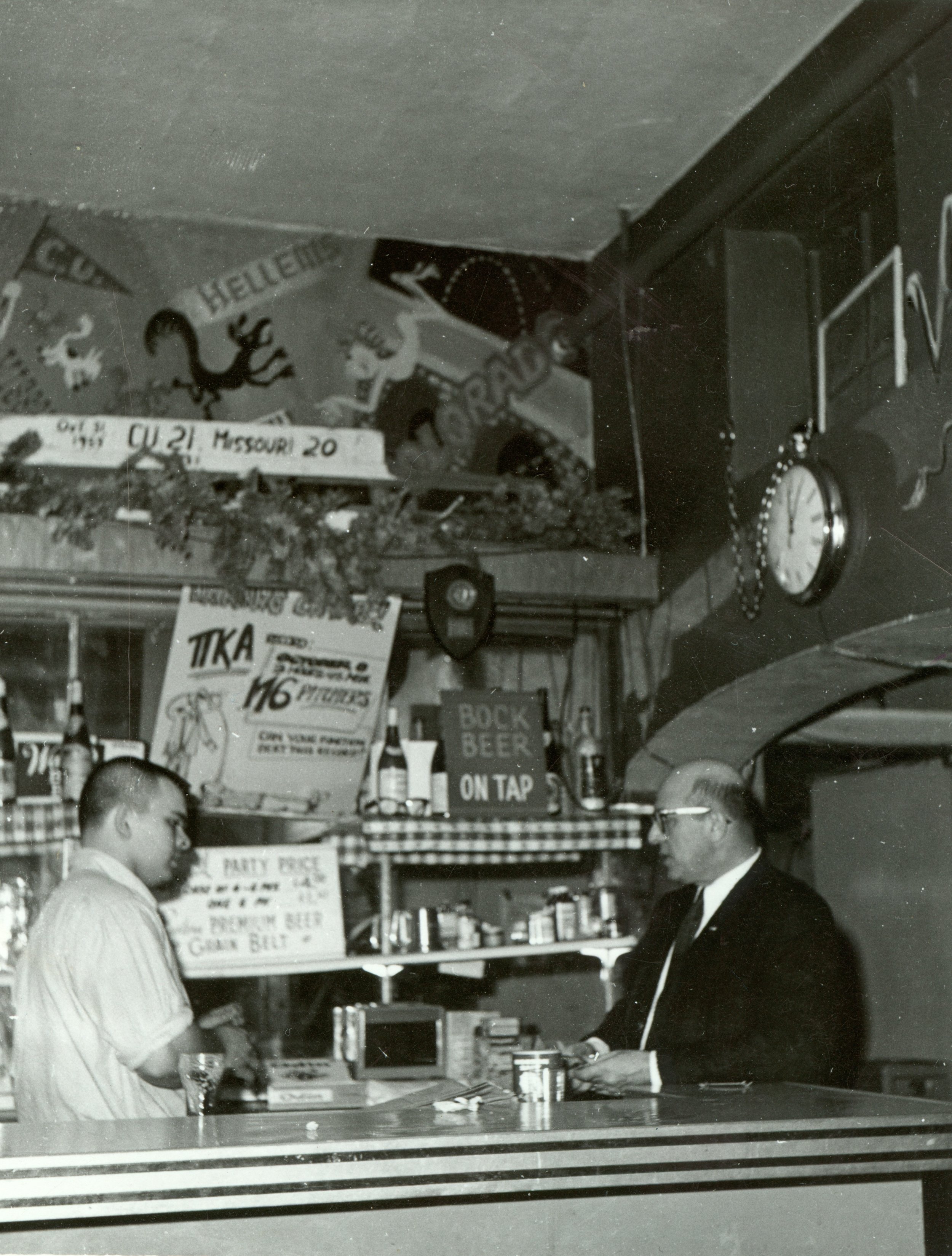 Black and white image of Floyd Marks and an employee behind the bar at The Sink in the 1950s when the bar was in the front room