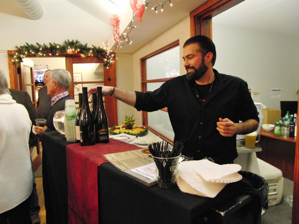 Sink employee working a private event serving wine and beer at a Christmas party