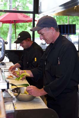 Chef and line cook in the kitchen preparing healthy salads in The Sink's kitchen