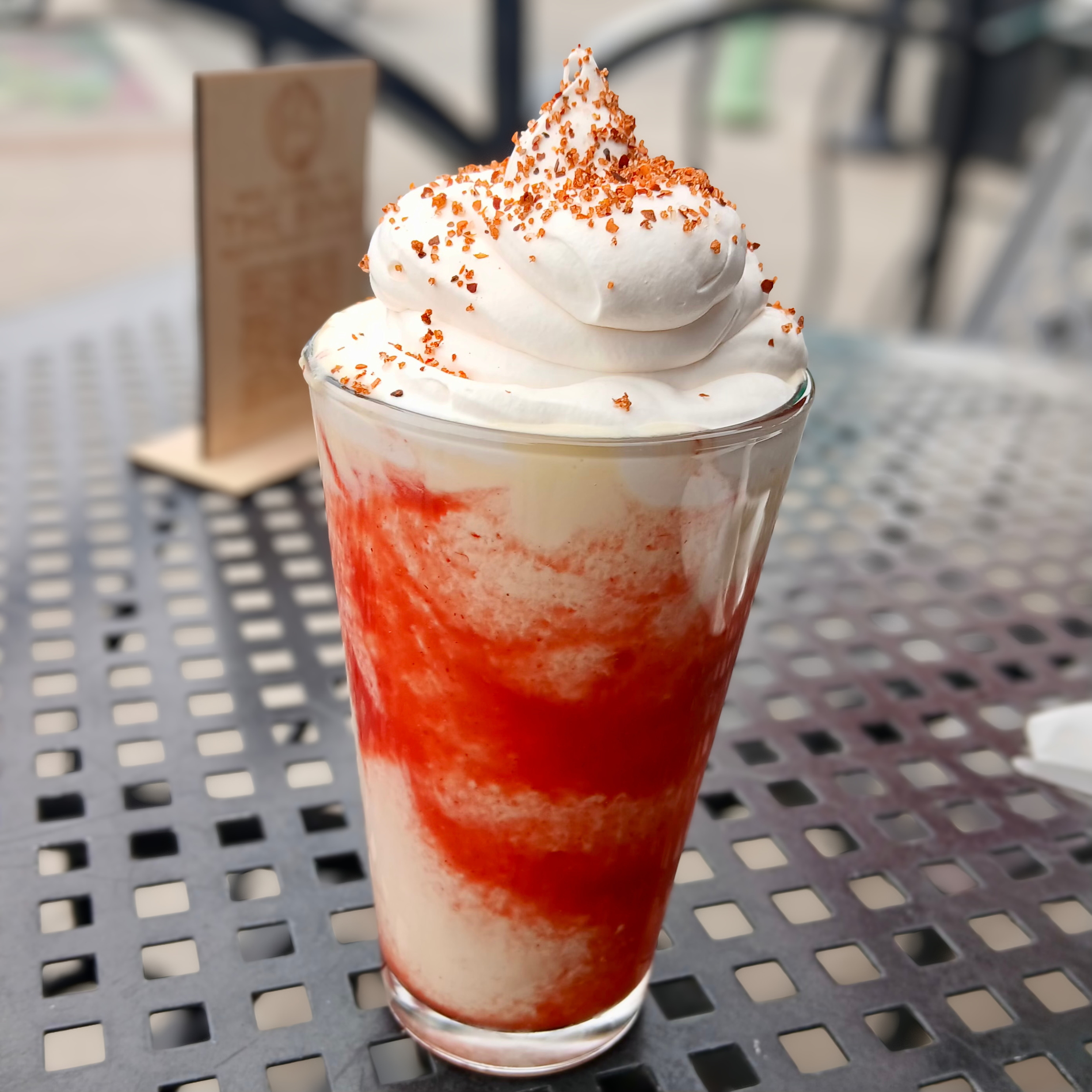 Strawberry-Mango Fiesta  Real vanilla bean ice cream hand-spun with mango and strawberry puree, topped with whipped cream and tajin