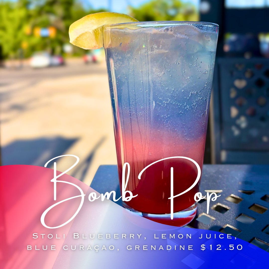Layered red and blue drink in a pint glass with a lemon garnish