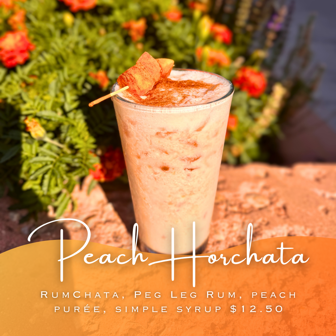 Peach Horchata cocktail in front of flowers in the sun
