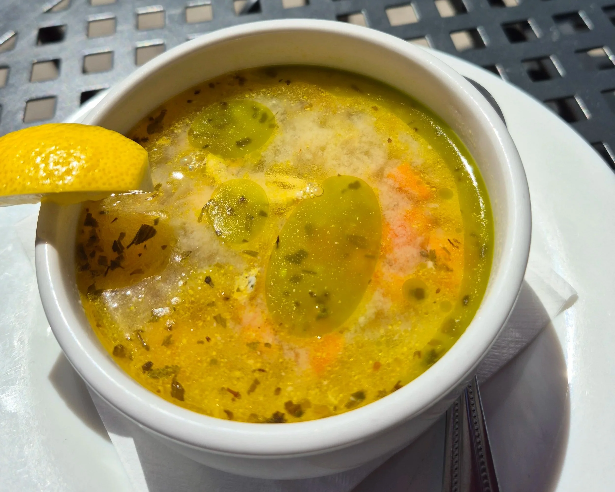CUP OF GREEK LEMON CHICKEN  Shredded chicken, celery, carrots, onion, garlic, egg whites, and lemon juice, topped with basil oil