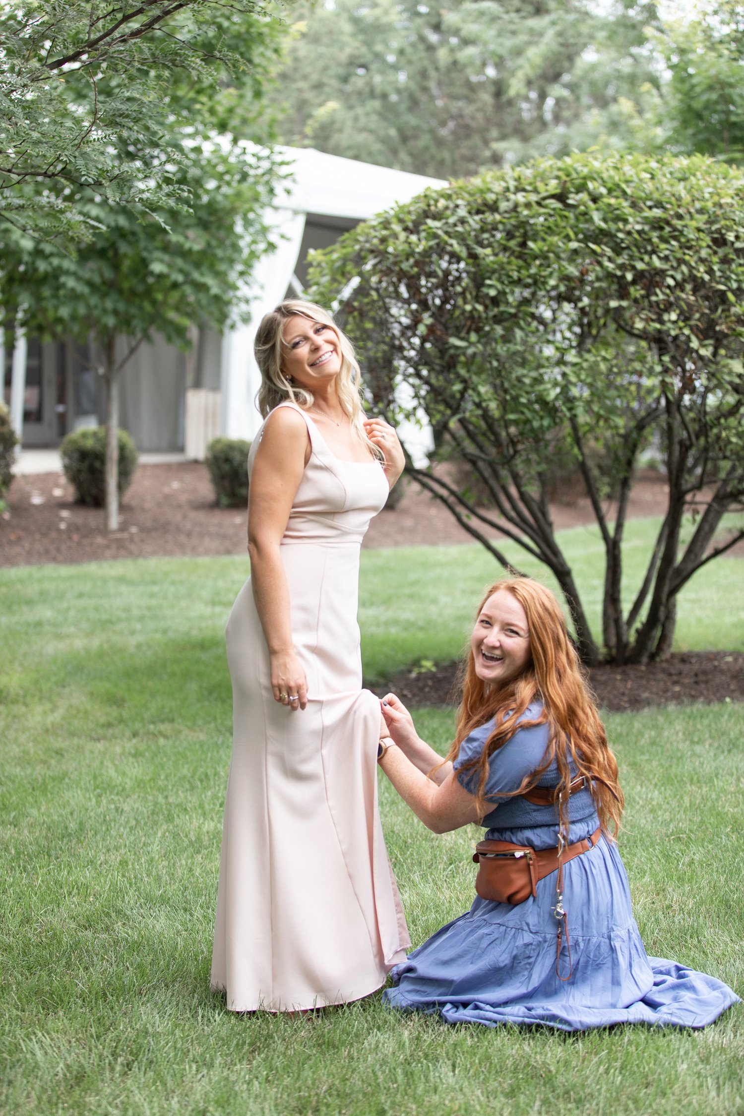 Elyse helping a bride with her dress