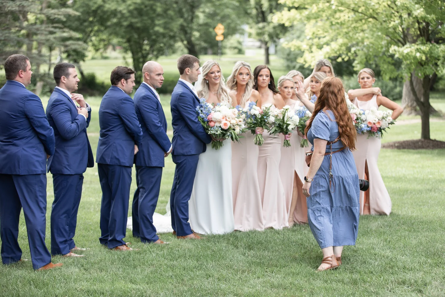 Elyse arranging a wedding party for their photograph