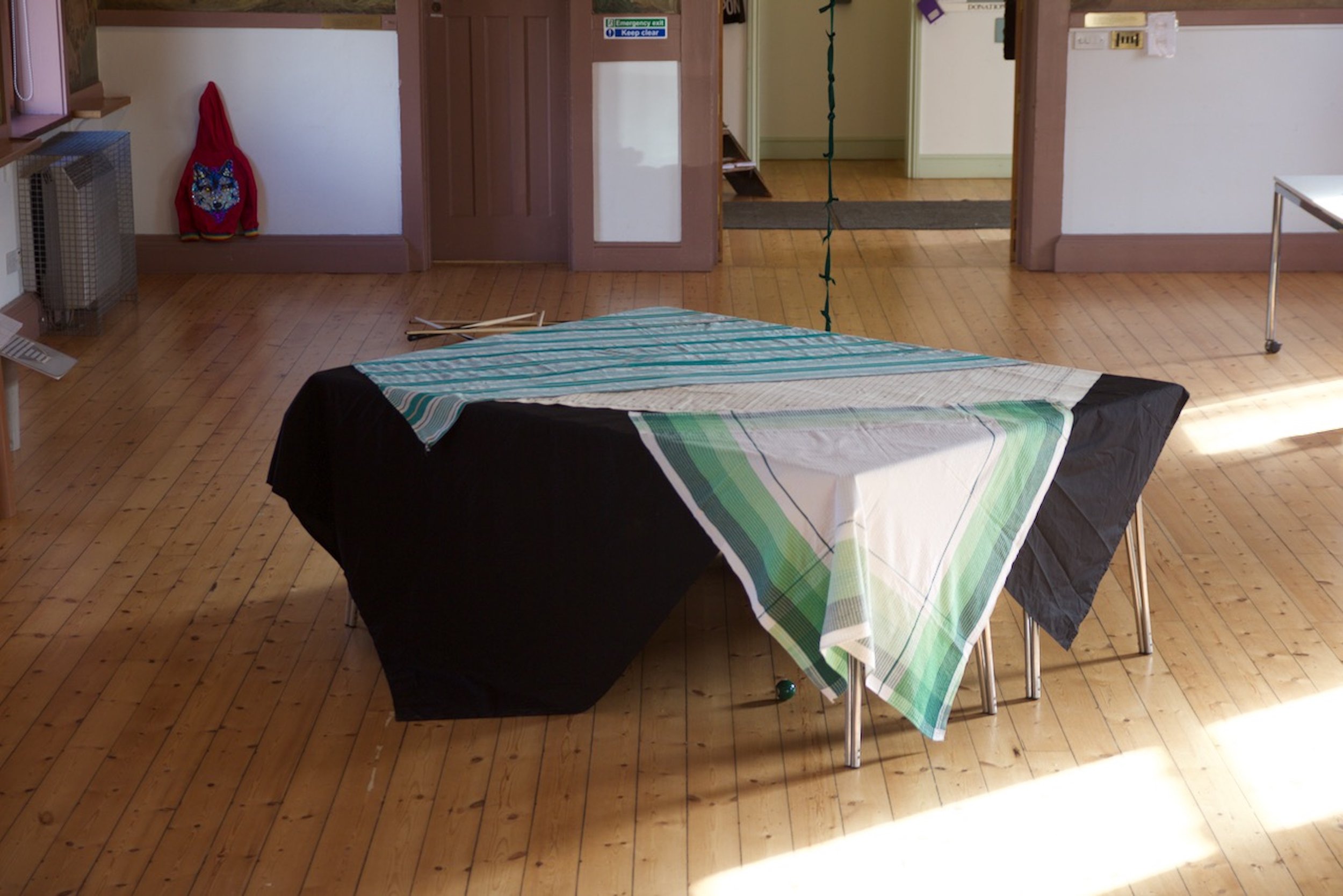 Laura Eldret, Incommon (table), 2022. Cloths on table, sizes variable.