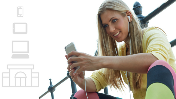 Woman smiling while viewing media on her iphone