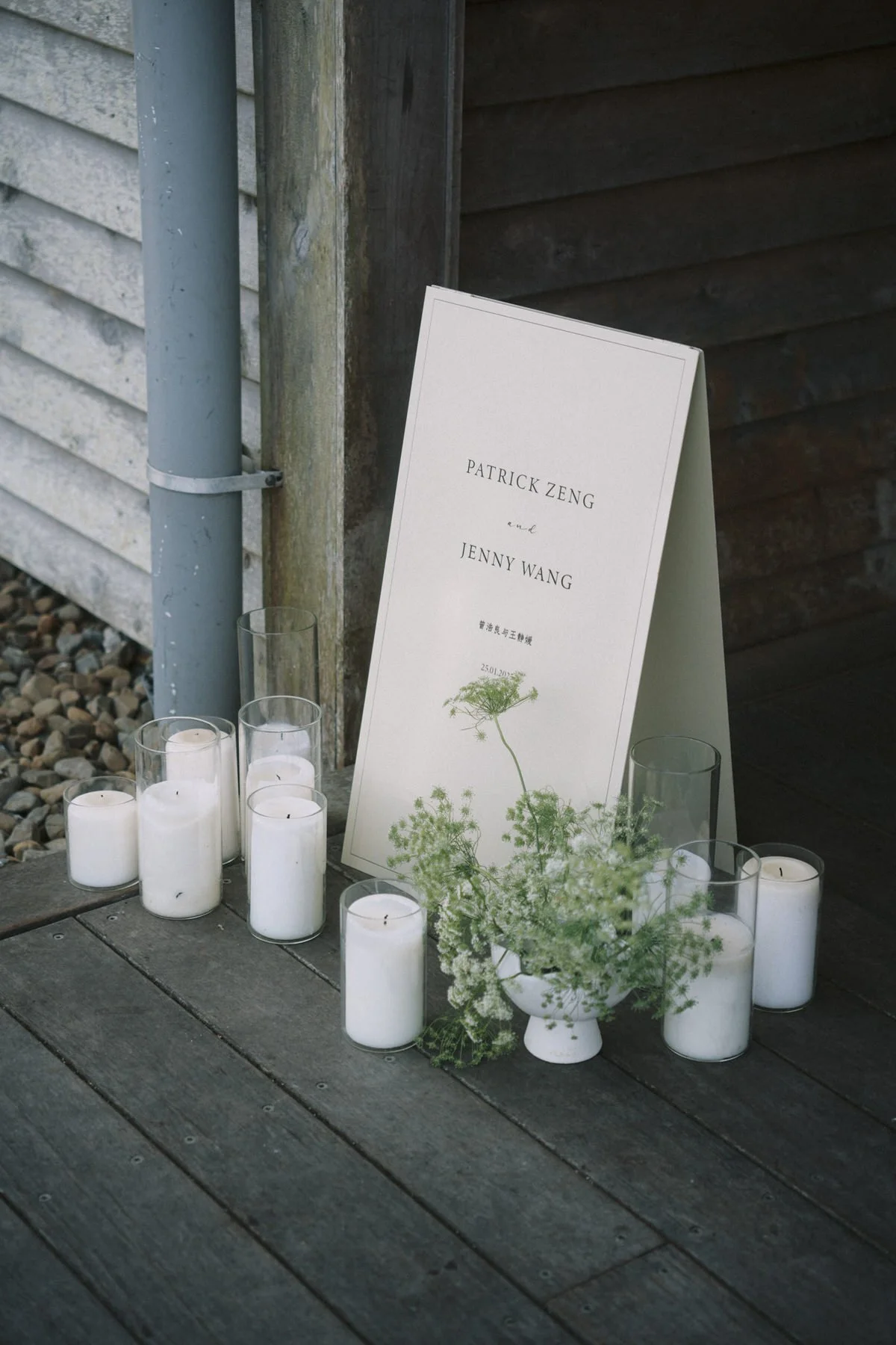 Wedding welcome sign decorated with seasonal white flowers.