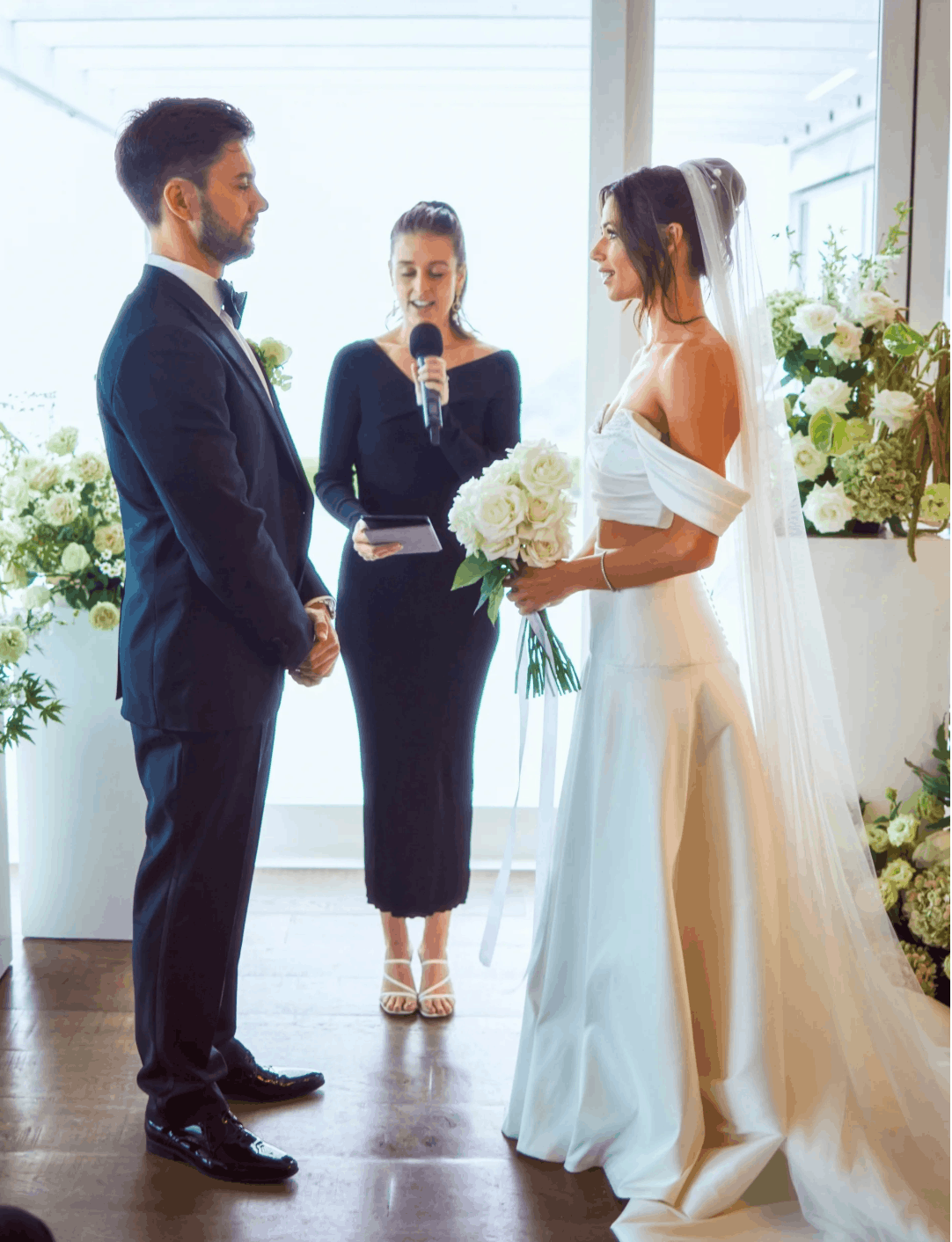 White rose ceremony flowers creating a timeless wedding setting.