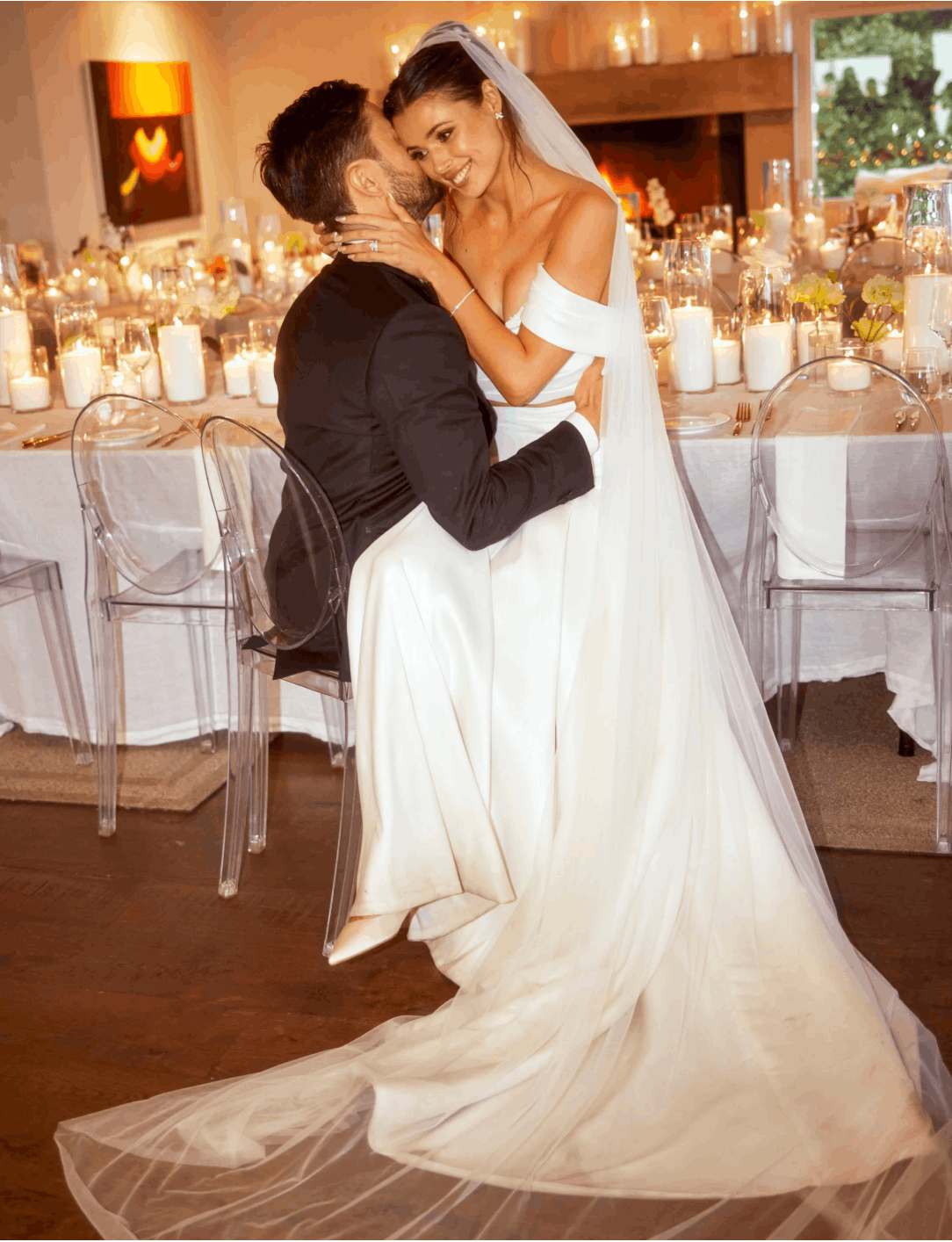 Romantic wedding table styling featuring candles and white flowers.