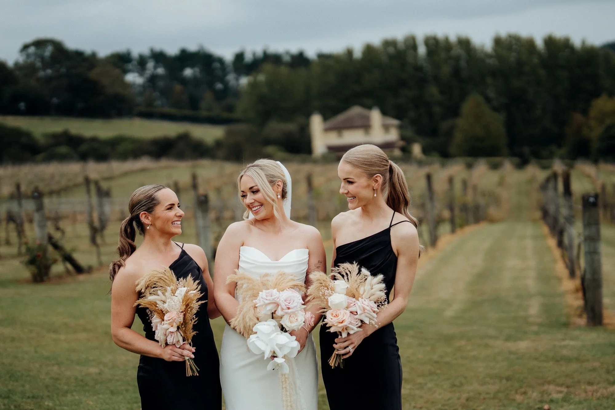 Nikki walking through the vineyard with her bridesmaids