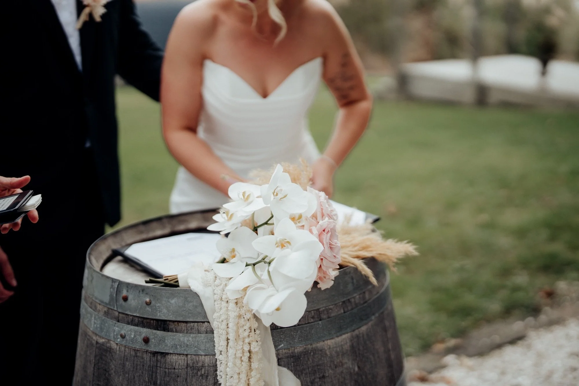 Bridal bouquet resting on the wine barrel