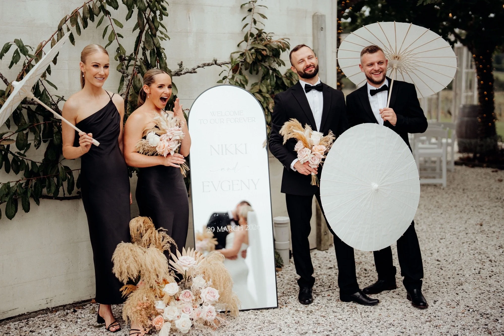 Bridal party beside the personalised mirror sign