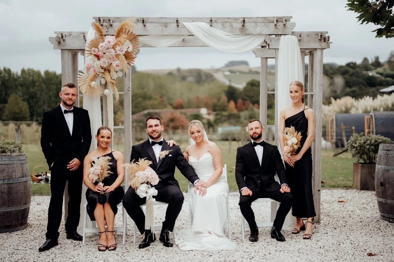 Soft blush, peach and ivory for Nikki and Evgeny at Turanga Creek.

For this romantic vineyard wedding, we paired fresh roses, orchids and anthuriums with sculptural dried palms and feathery textures. From Nikki&rsquo;s softly cascading bouquet to th