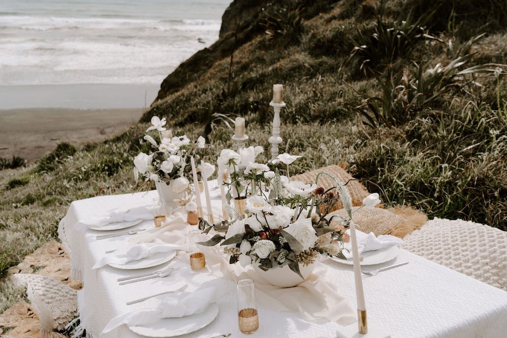 Romantic elopement table flowers featuring white and blush blooms on an intimate West Coast wedding tablescape in New Zealand.