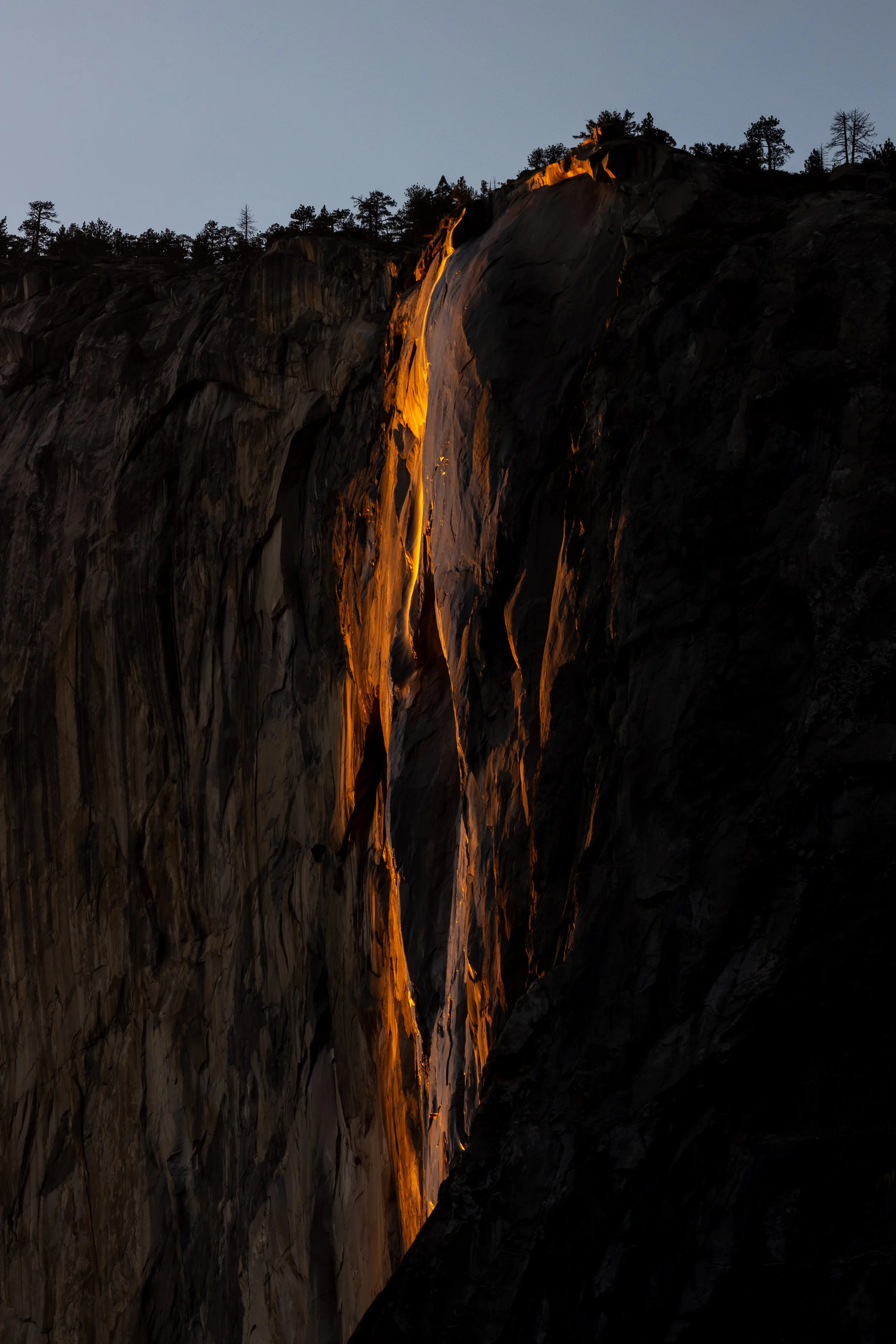 Horsetail Fall at Yosemite National Park glowing orange at sunset during the rare Firefall phenomenon