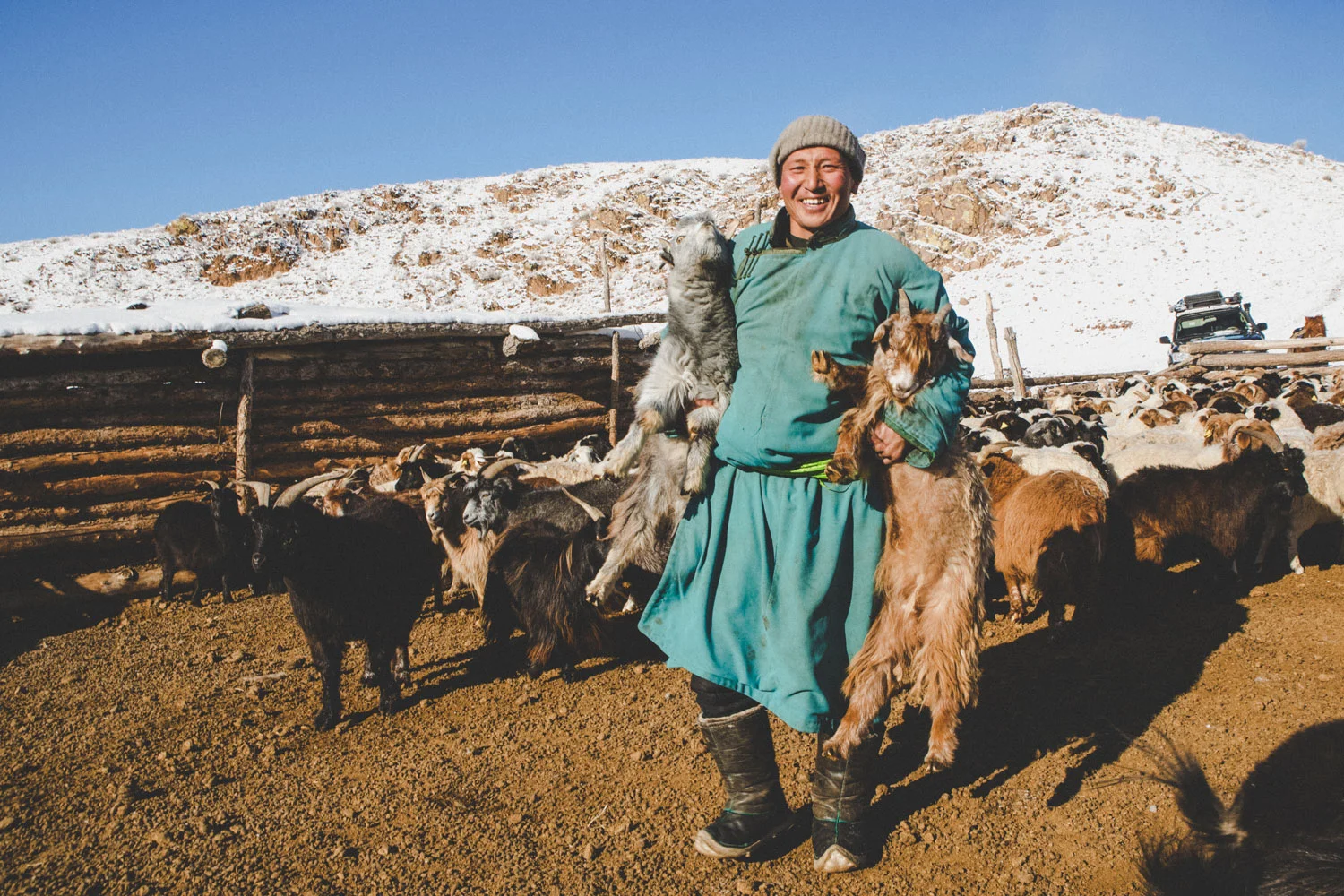 herder-holding-two-goats.jpg