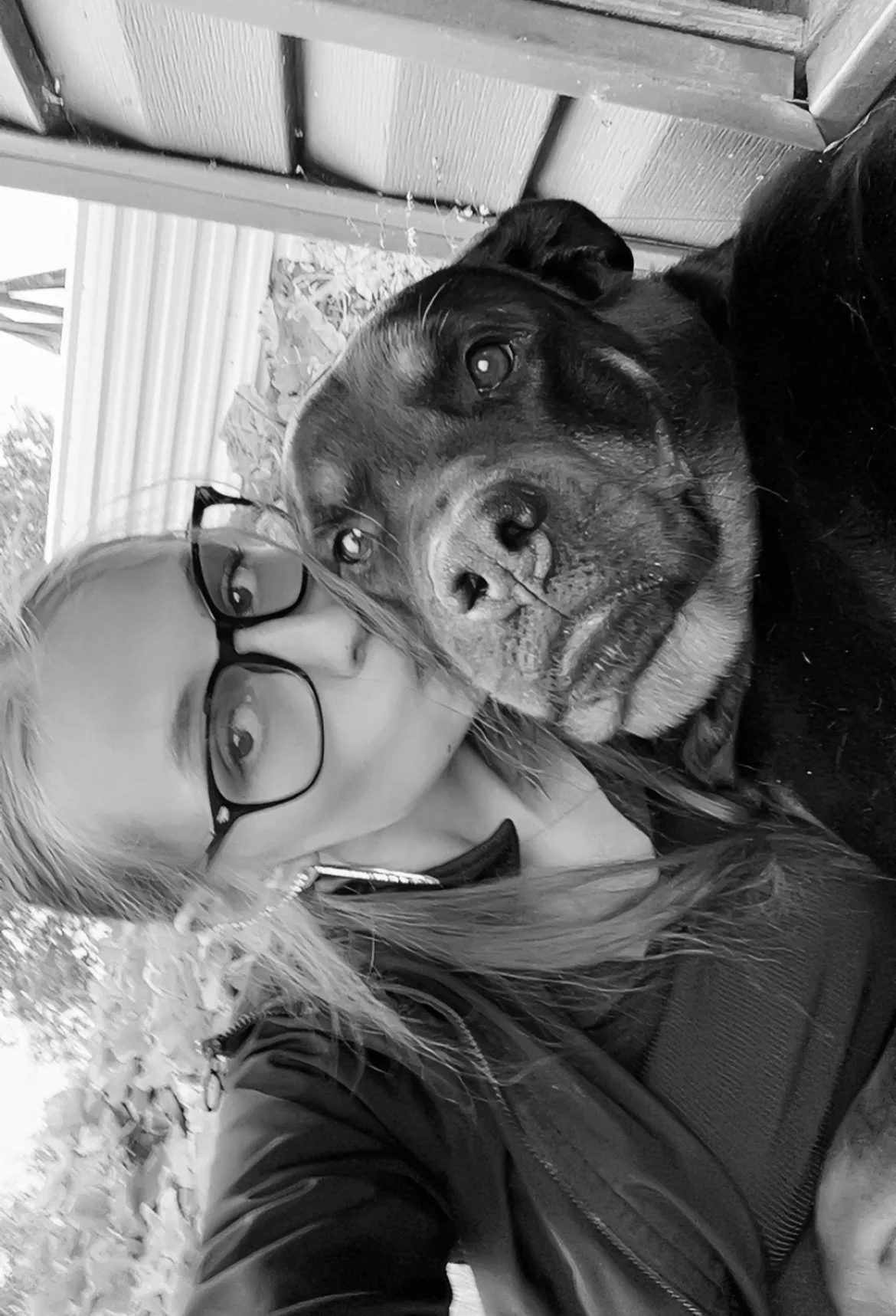 A reflection of a city street in a window with a sign that reads 'COMING SOON' in bold letters.