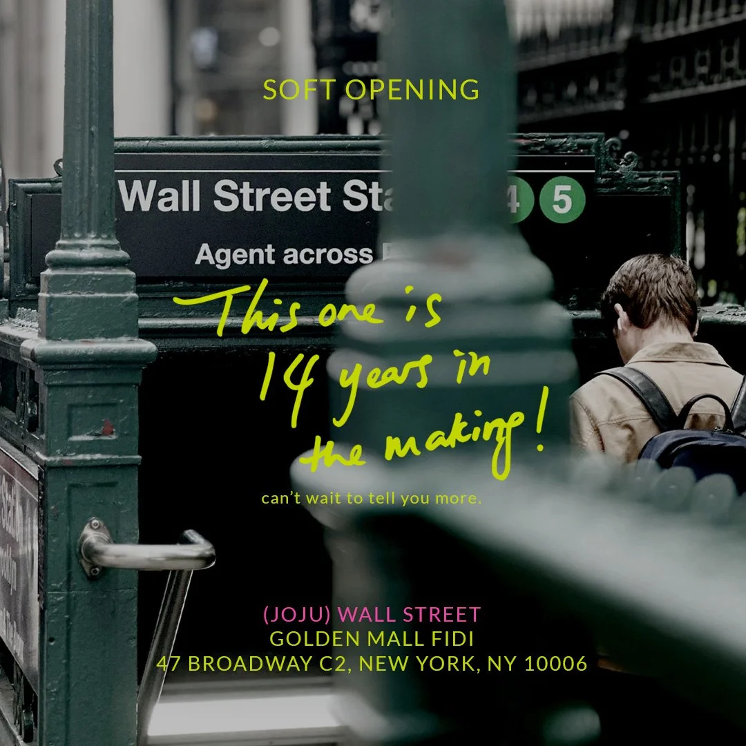 Wall Street subway station entrance with green railing and a person walking downstairs; overlay text announces (JoJu) Wall Street's soft opening, "14 years in the making," at Golden Mall FiDi, 47 Broadway C2, NY.