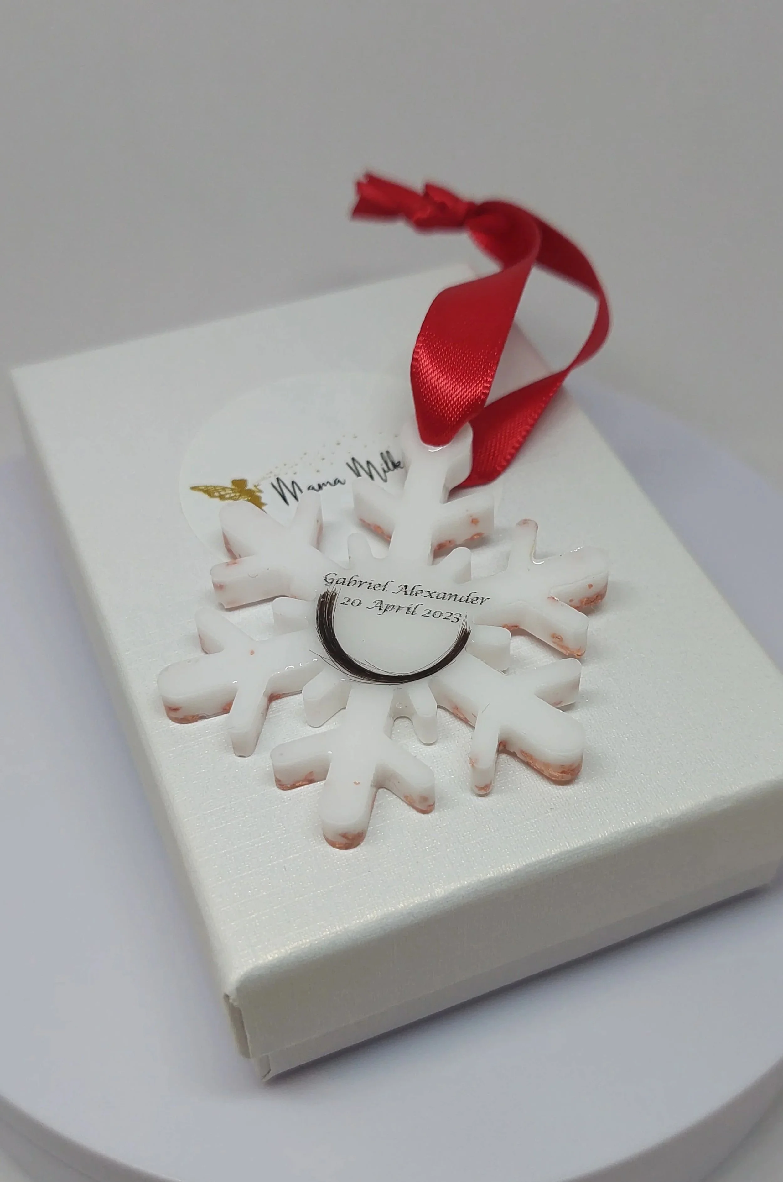 breastmilk-ornament-with-babys-lock-of-hair.jpg