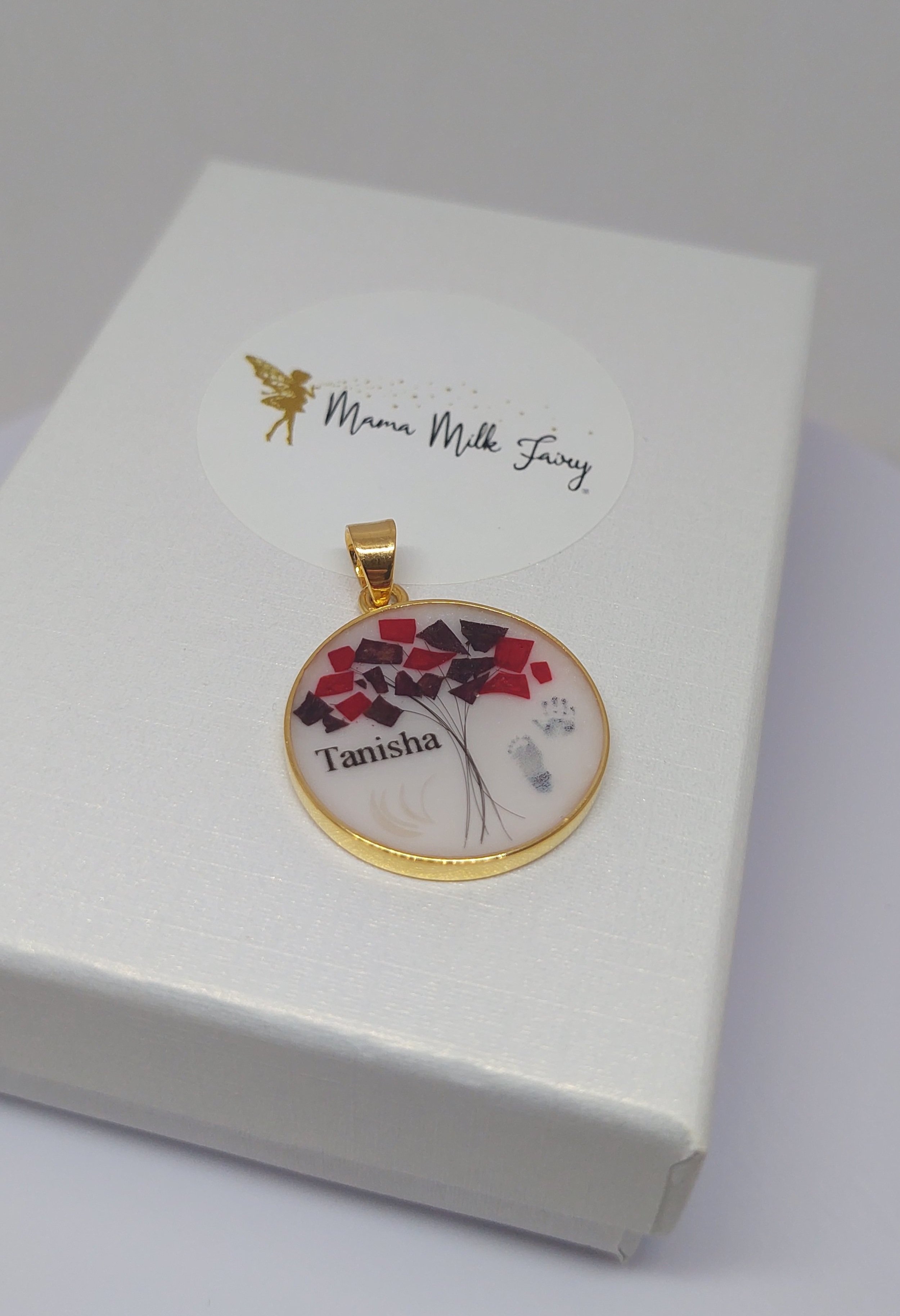 baby's hand and foot print in a breastmilk pendant