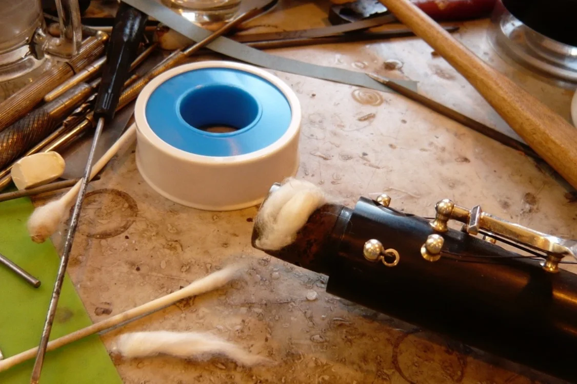 Unravel some cotton from the Q tip and pack it in the area with the missing cork.