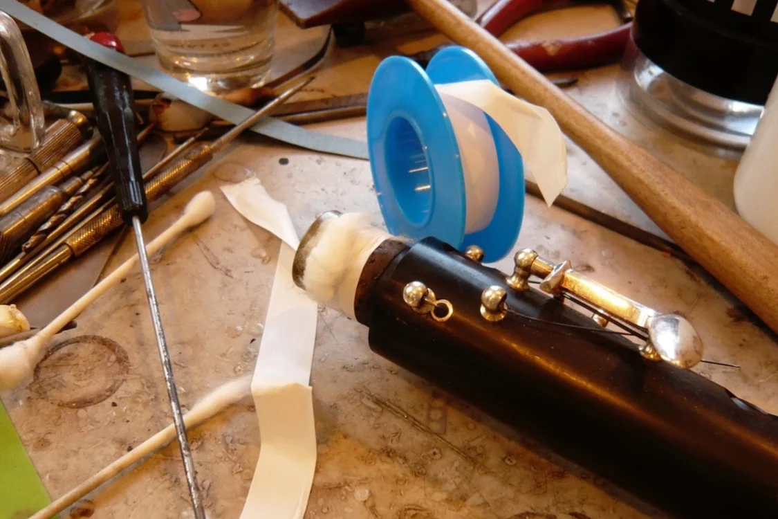 Wrap the tape around the cork and cotton several times, pulling firmly as you go.