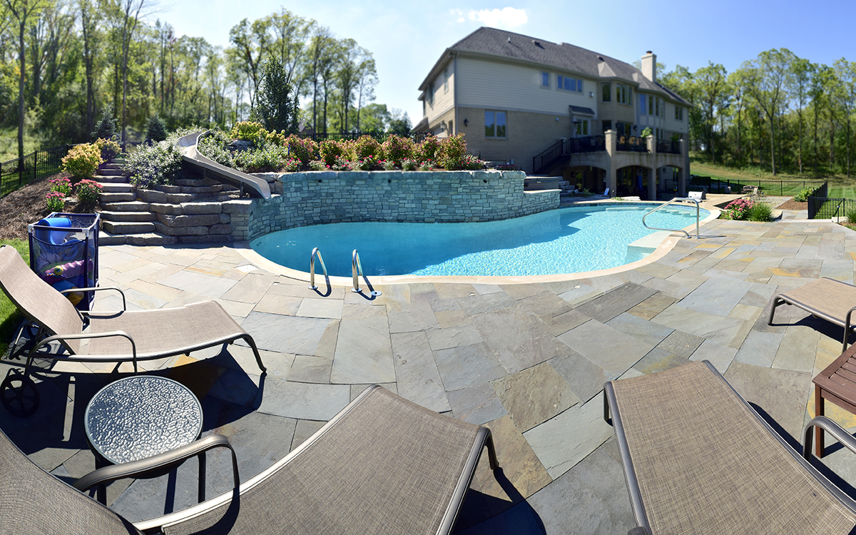 Top landscape design in Brighton MI - pool with outdoor fireplace