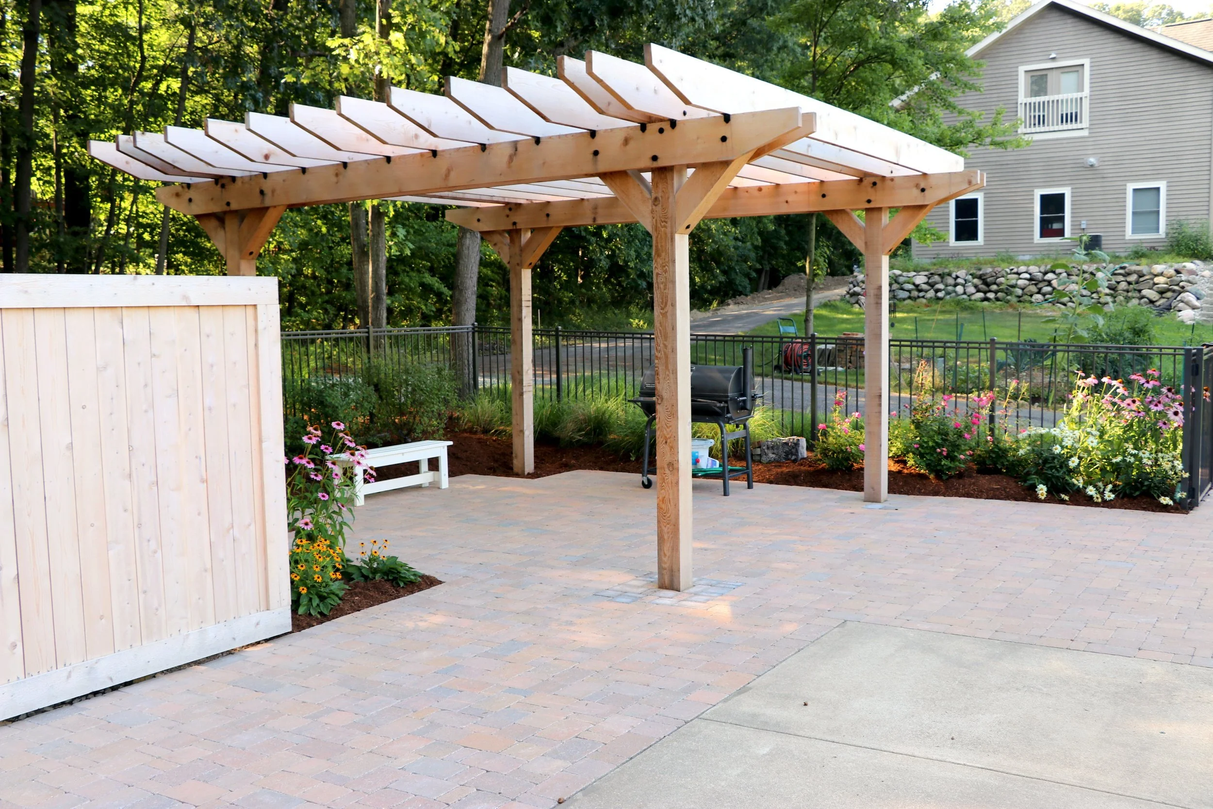 How a Custom Cedar Pergola and Seasonal Plantings Add Beauty to Your Backyard in South Lyon, MI
