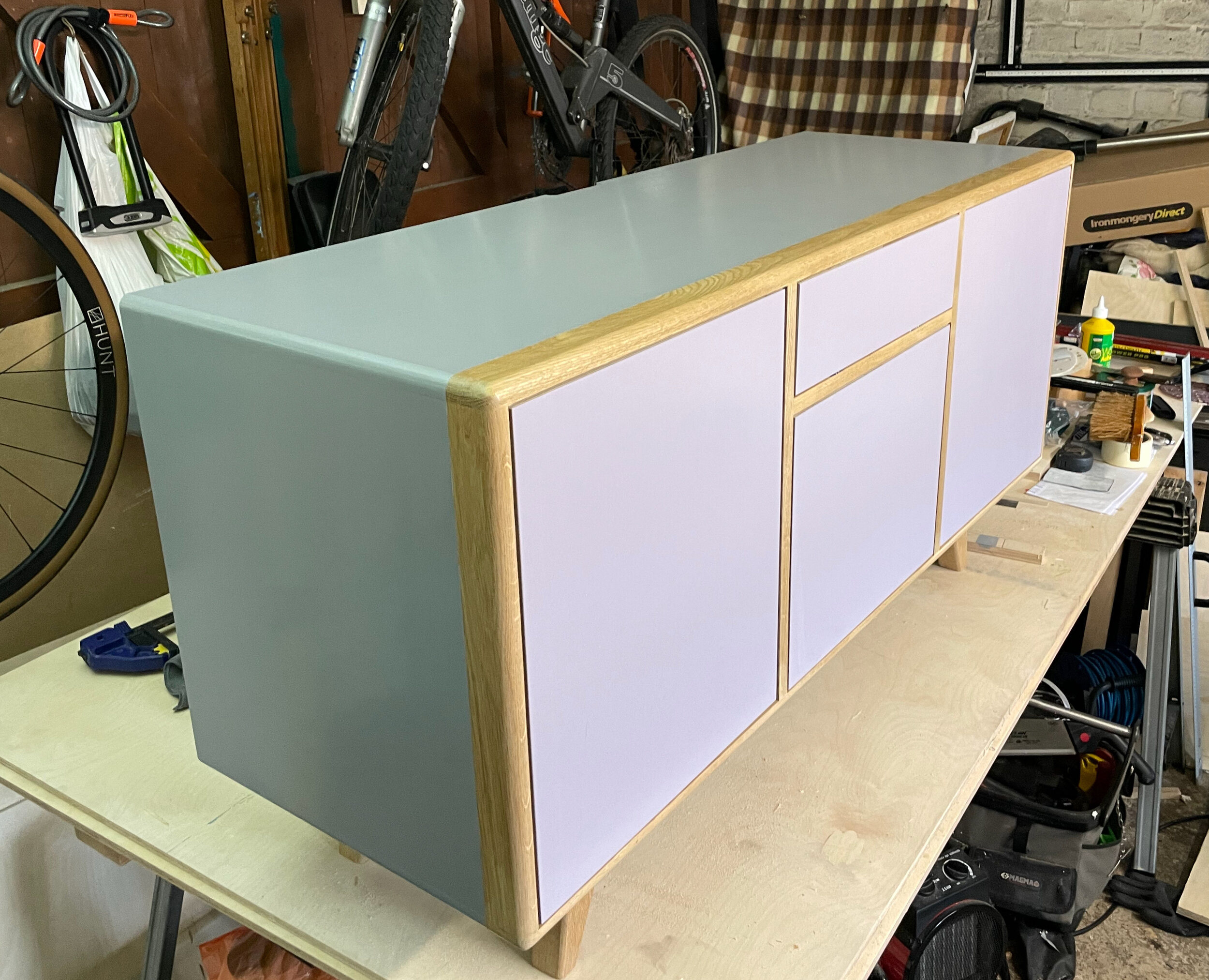 Set of four drawers, constructed from birch plywood, with oak lipping and feet. Colours custom mixed and handpainted. 1015mm tall, 850mm wide, 445mm deep. Soft close runners, milled and brushed steel handles