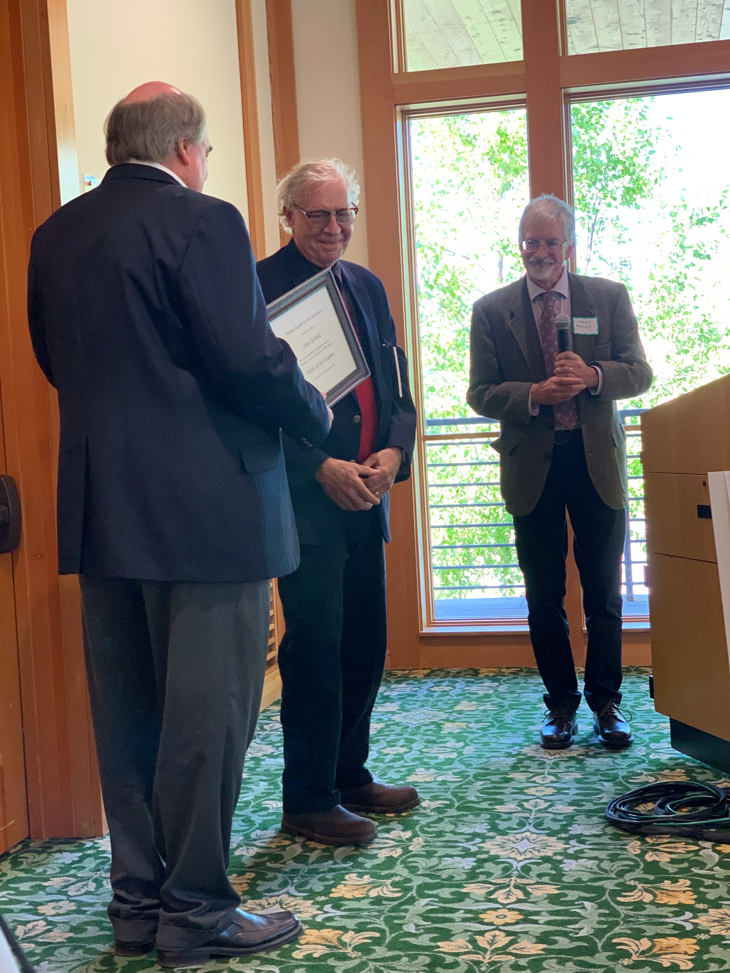 Author and Poet Laureate of Vermont, Chard deNiord is honored as a Fellow with Kevin Fleming and Jeff Marshall presenting