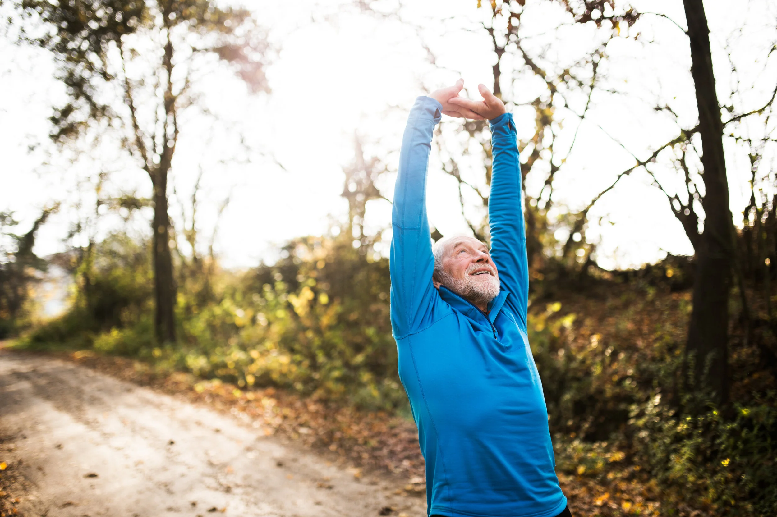 graphicstock-senior-runner-in-sunny-autumn-nature-doing-stretching-man-with-gray-beard-and-mustache-wearing-blue-sweatshirt-exercising_rODOaoBzW.jpg