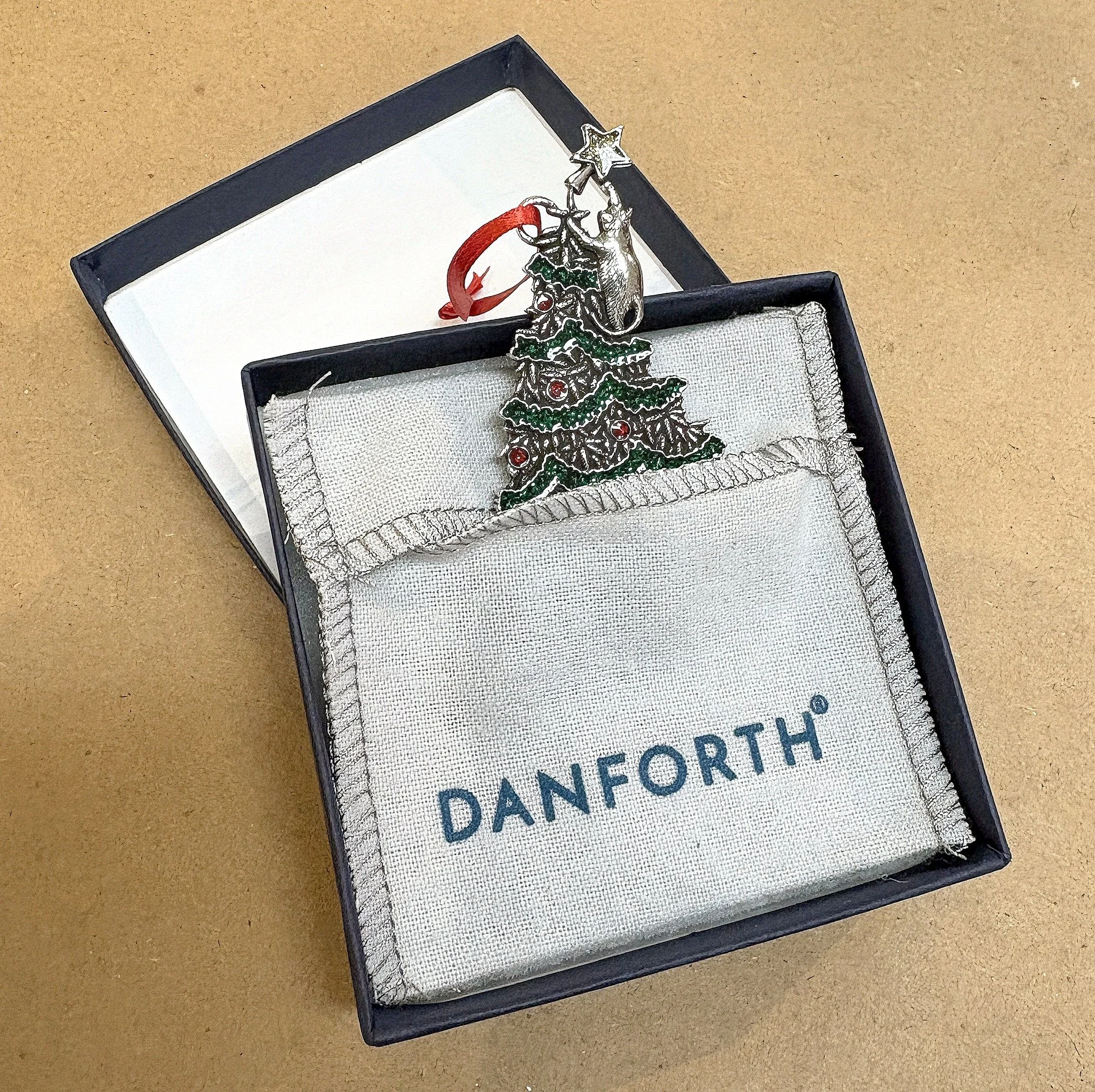 We just received a fresh batch of work from @danforthpewter and were pleasantly surprised to see that their ornaments now come in gift boxes with flannel pouches!

Not only is this a beautiful touch, but it adds protection for the ornaments. We are b