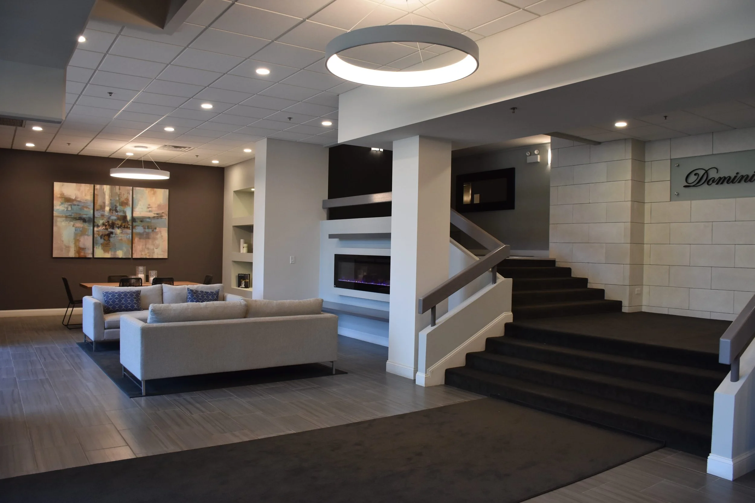 Renovated condominium lobby in Wood Dale, Illinois, completed by Expert Building Maintenance, Inc., featuring updated seating areas, lighting, flooring, finishes, and common area improvements.