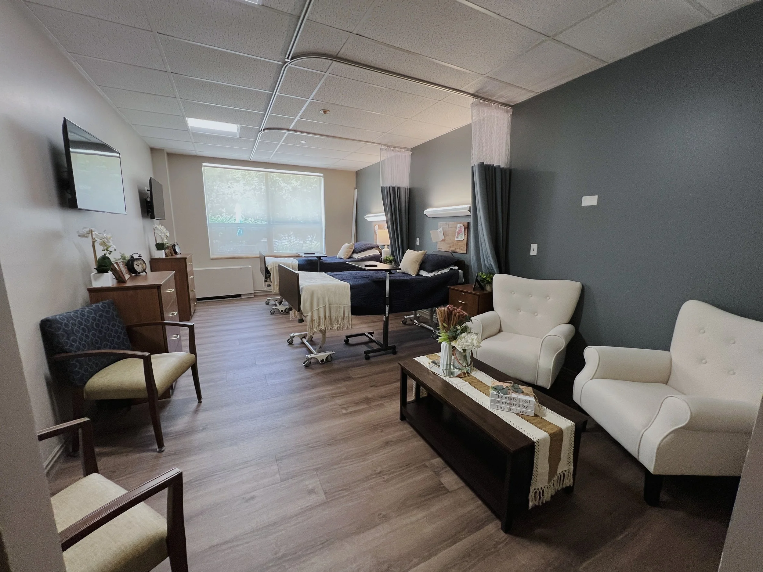 Renovated nursing facility patient room in Elgin, Illinois, completed by Expert Building Maintenance, Inc., featuring updated flooring, finishes, seating, lighting, and resident room improvements.