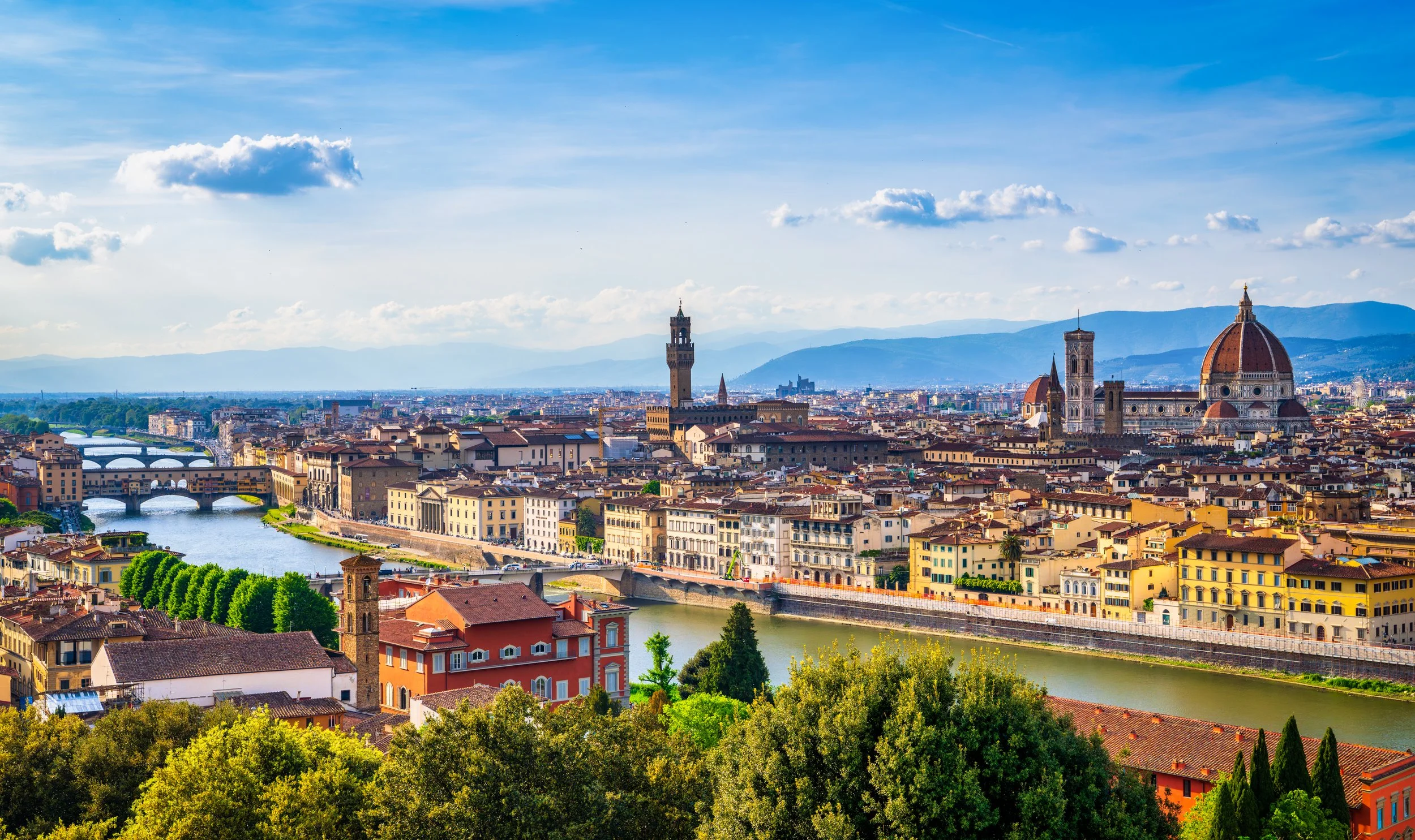 A breathtaking panoramic view of Florence from Piazzale Michelangelo, featuring the Arno River, Ponte Vecchio, Palazzo Vecchio, and the iconic Cathedral of Santa Maria del Fiore. Fine art travel photography capturing the timeless beauty of Tuscany's 
