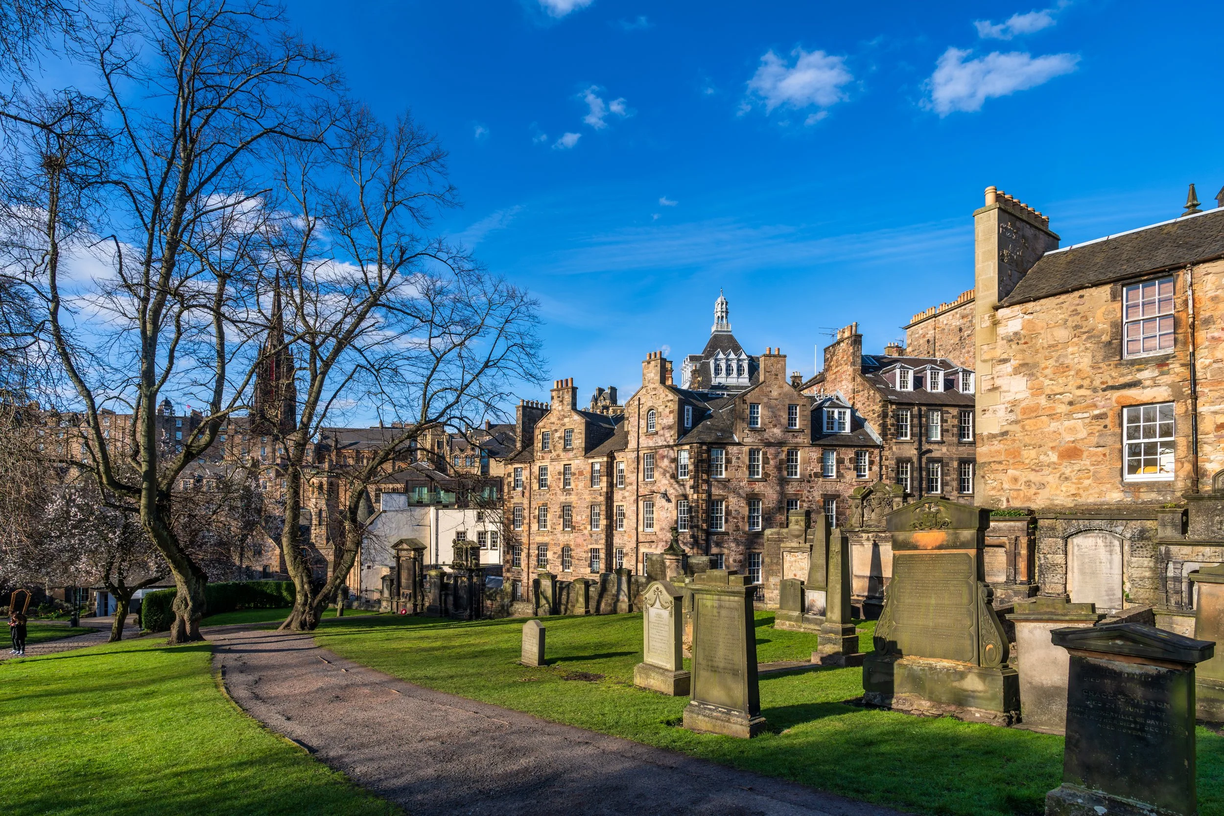 Historic Greyfriars Kirkyard in Edinburgh, Scotland, surrounded by traditional stone buildings in the heart of the Old Town.